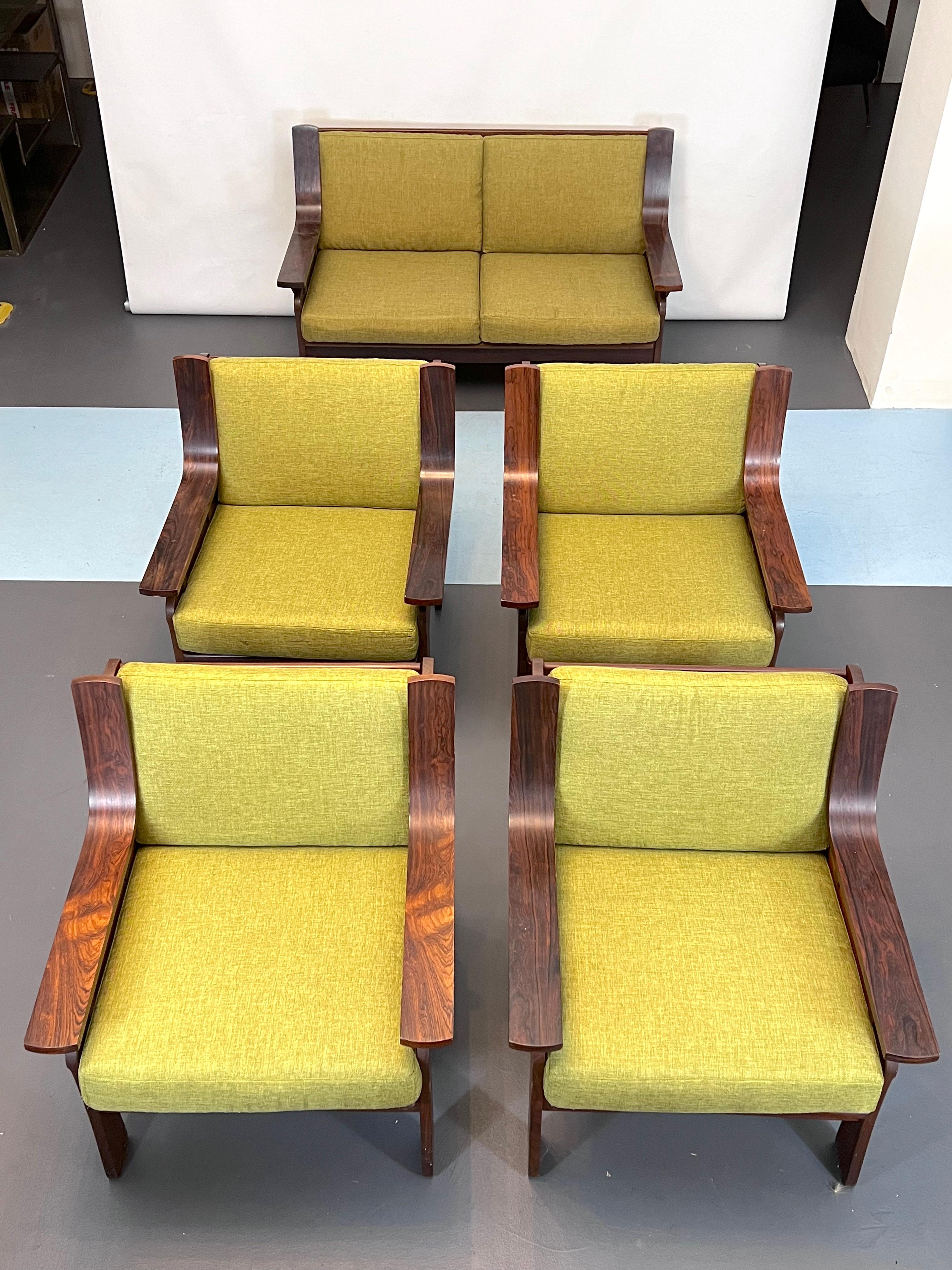 Great vintage condition with normal trace of age and use. The set consists of 4 armchairs and a two-seater sofa, made from wood and green fabric. Produced in Italy during the 60s. Measures: Armchair dimensions H 79 W 72 D 72, Sofa dimensions H 79 W