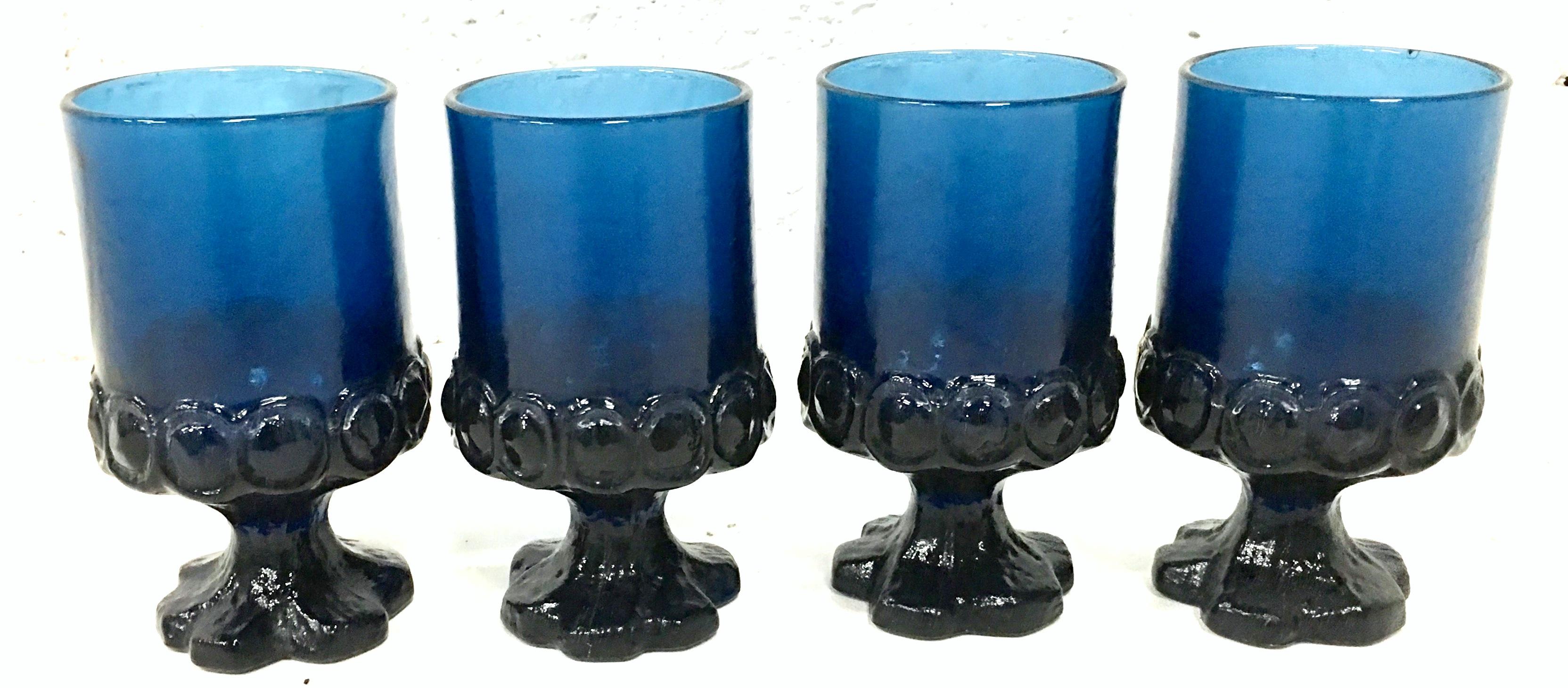 Midcentury set of four American glass stem cobalt thumbprint drink glasses.