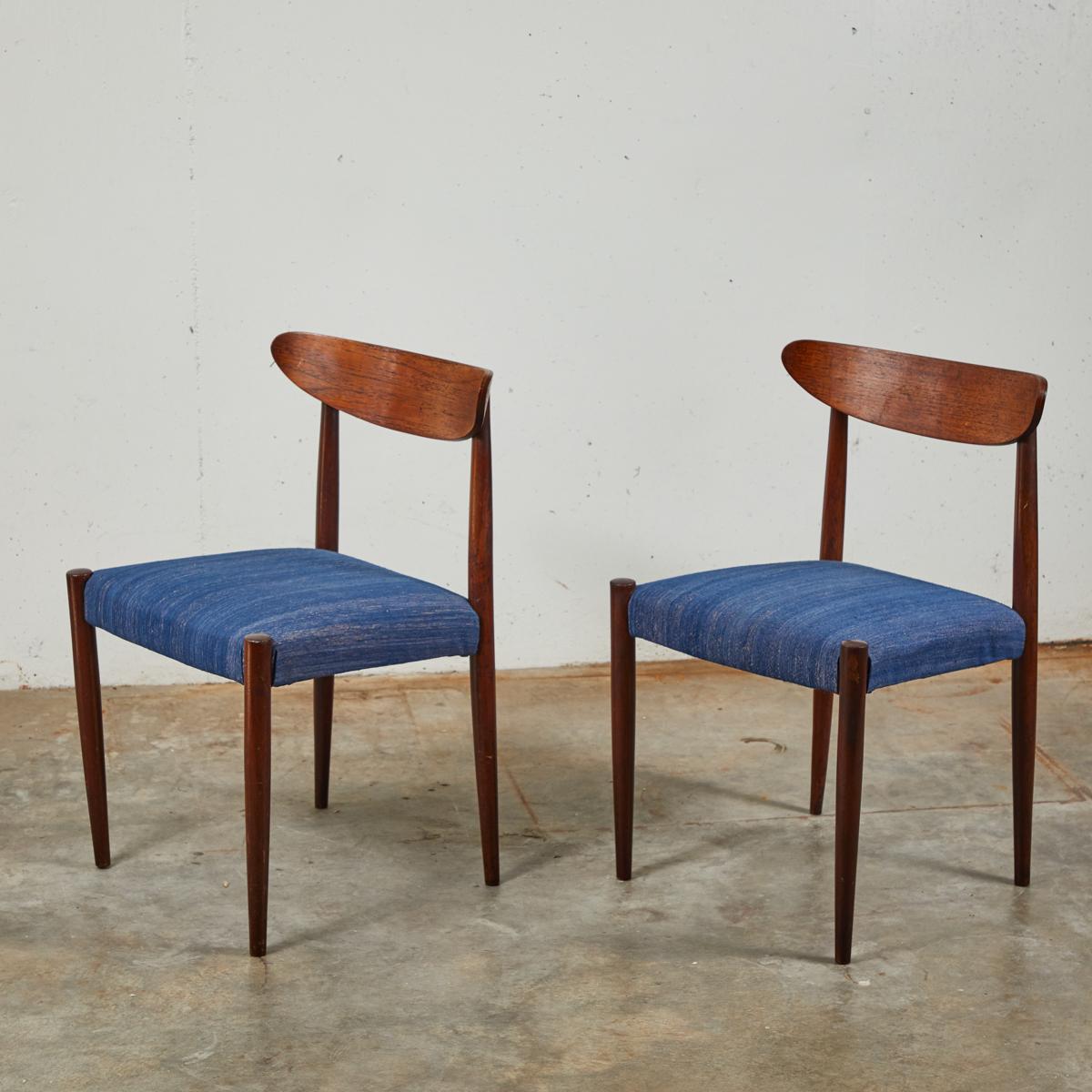 Pair of Mid century dining chairs with tapered legs upholstered in a textured blue fabric. 