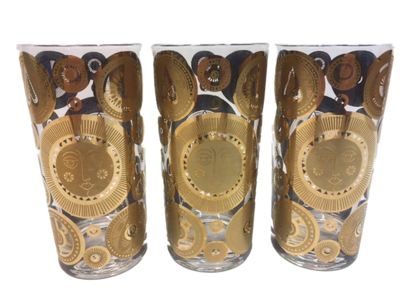 Set of 6 vintage Georges Briard highball glasses with various size circles of 22k gold over blue enamel. The circles embossed and pierced with designs of the sun and leaves with only the gold visible on the exterior with the design visible in the