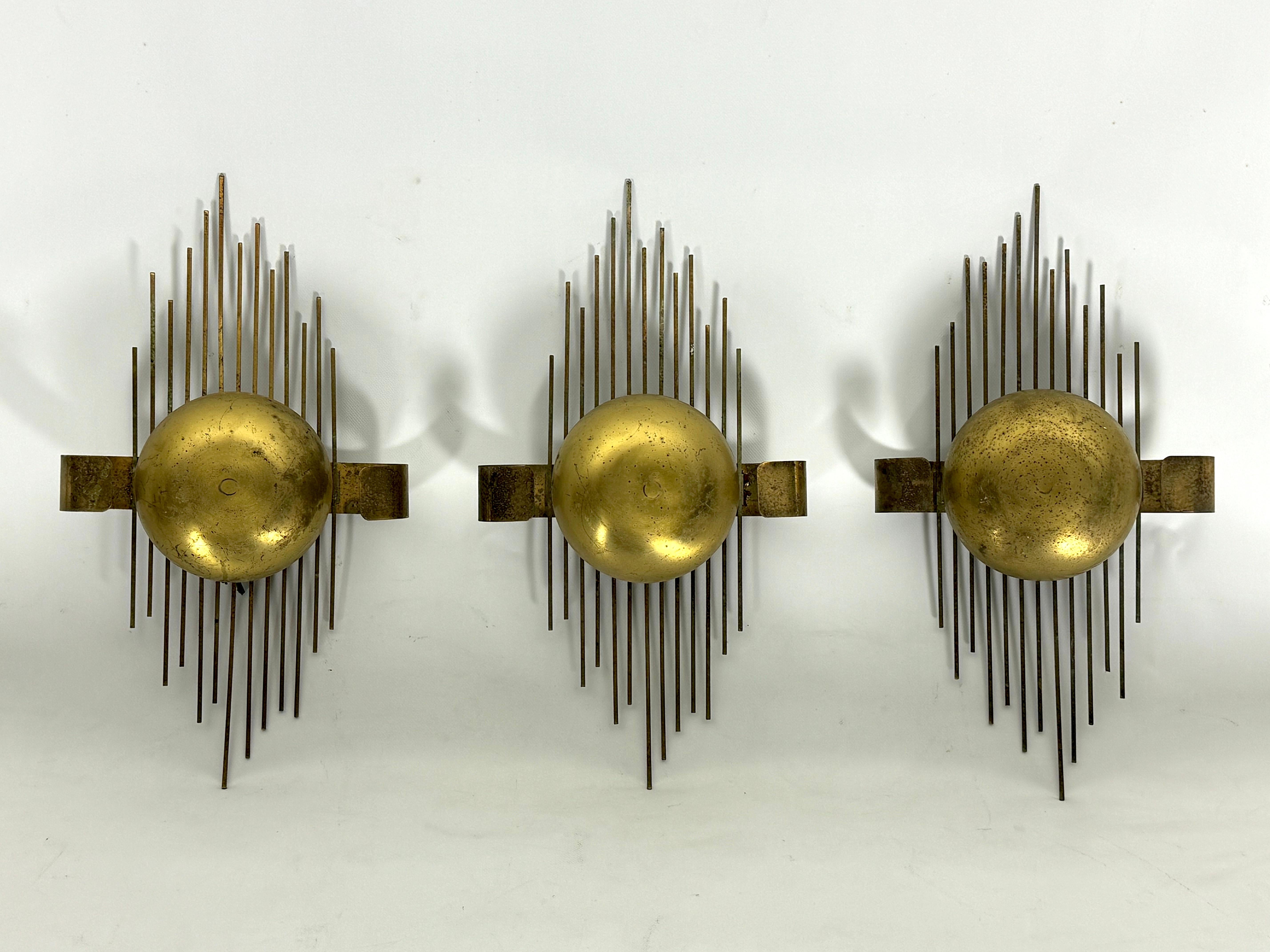 Seltener Satz von drei Wandlampen aus vergoldetem Metall, die in den 50er Jahren in Italien hergestellt wurden. Angemessener Vintage-Zustand mit Verlust der Vergoldung und deutlichen Alters- und Gebrauchsspuren. Voll funktionsfähig mit EU-Standard,
