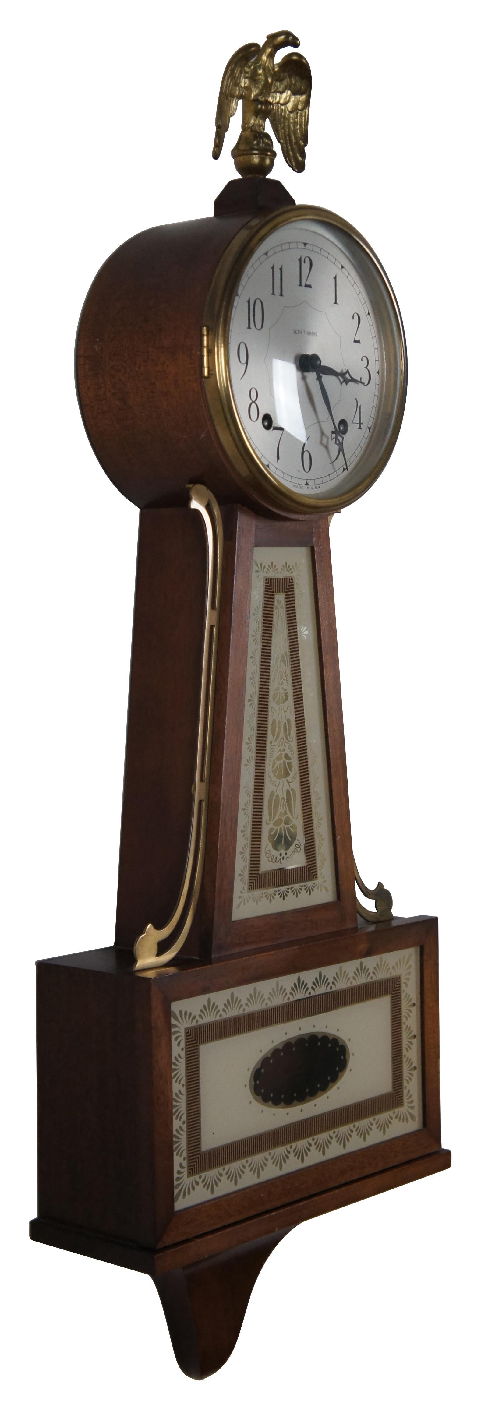Vintage 1950s Seth Thomas Brookfield Colonial banjo style 8-day spring wound, pendulum, chiming wall clock with eagle finial. “Fabulous re-creation of the circa 1810 Willard Banjo Clock. Brass eagle and trim, convex crystal, strikes the half-hour