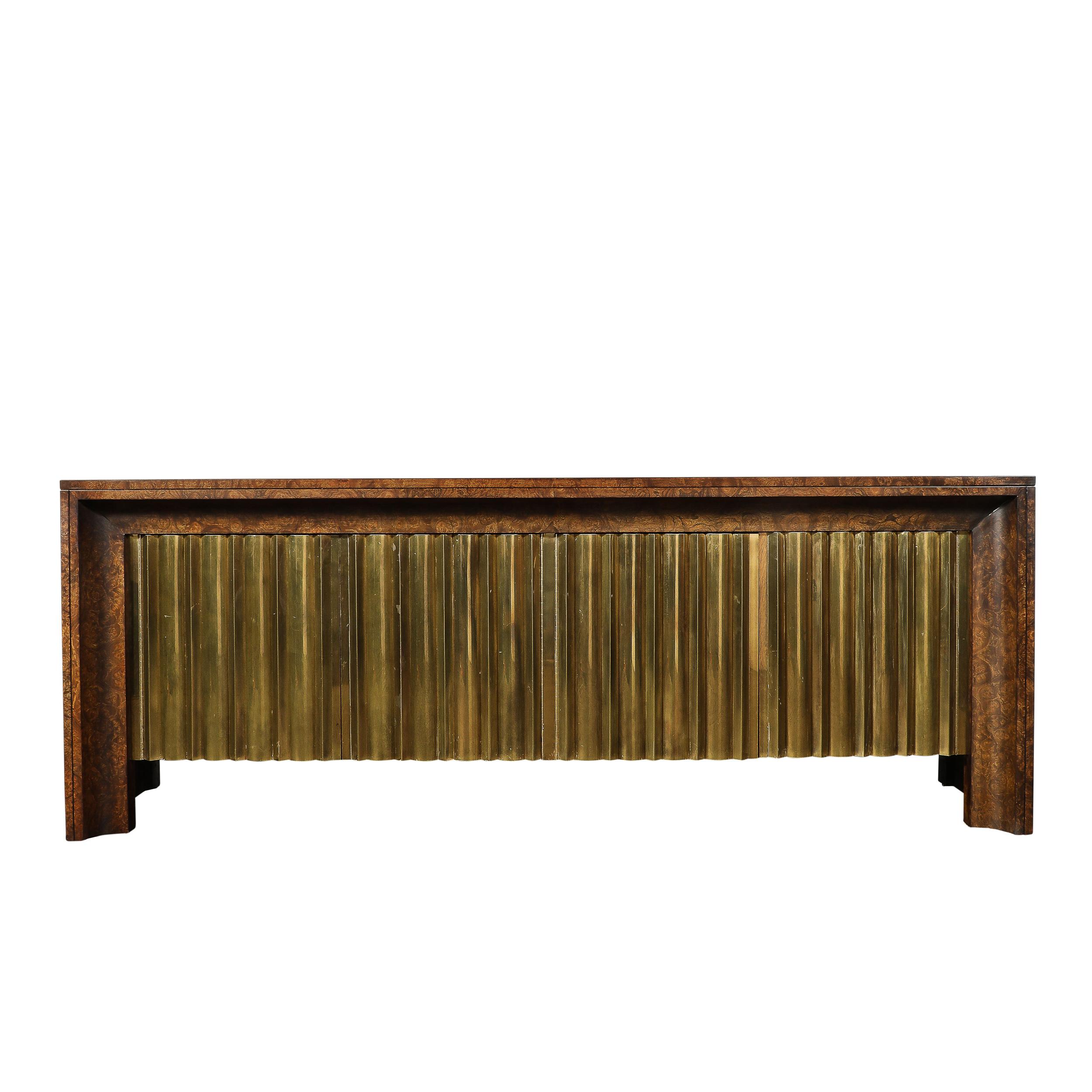 This highly unique and materially exquisite Mid-Century Modernist Shadowbox Sideboard in Book-Matched and Burled Carpathian Elm with Macassar Inlays and Antiqued Brass Drawers signed by Mastercraft originates from the United States, Circa 1970. A