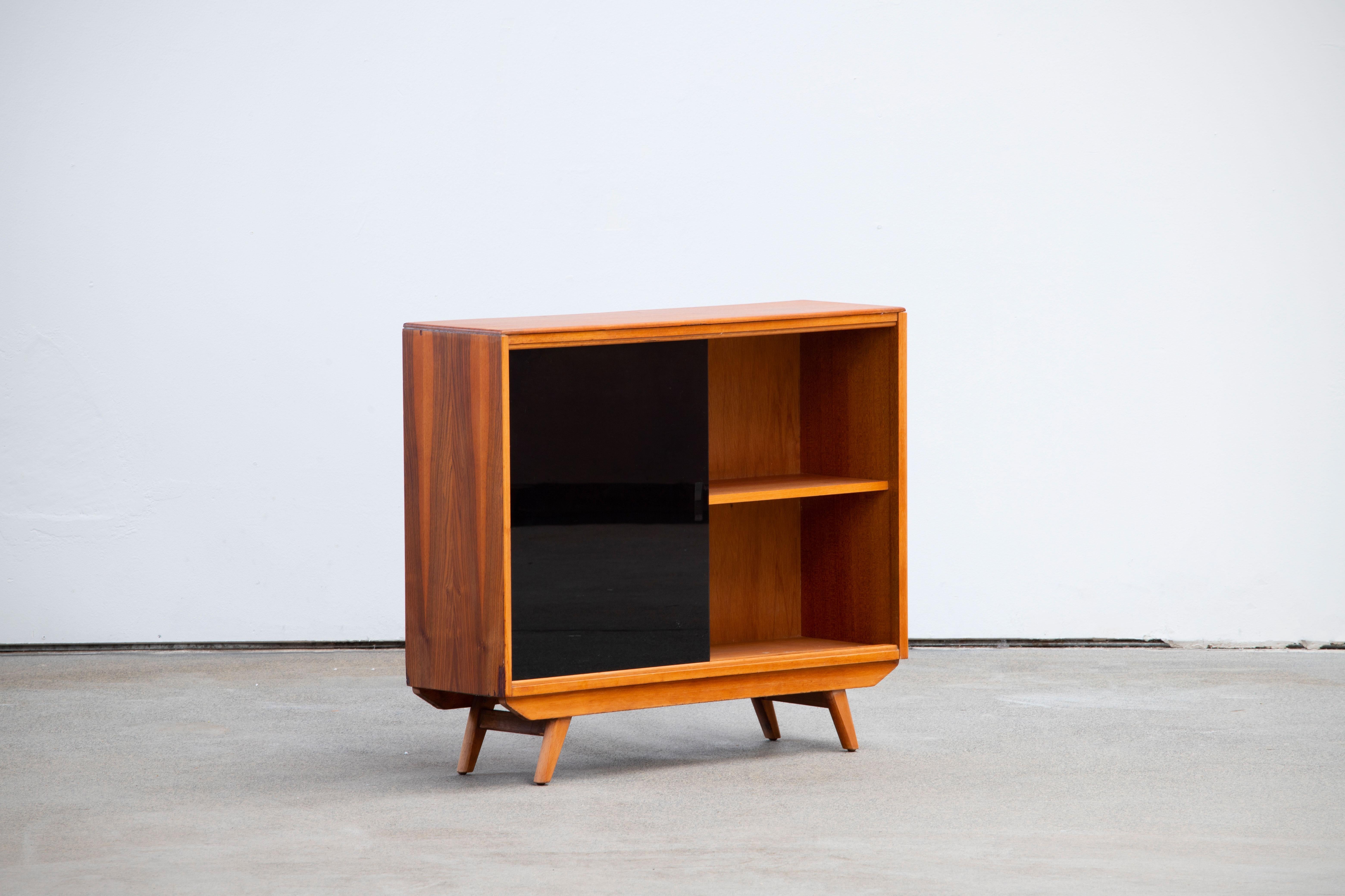 Beech walnut and sliding glass doors Credenza with compass feet. Its shallow depth allows it to furnish narrow spaces.