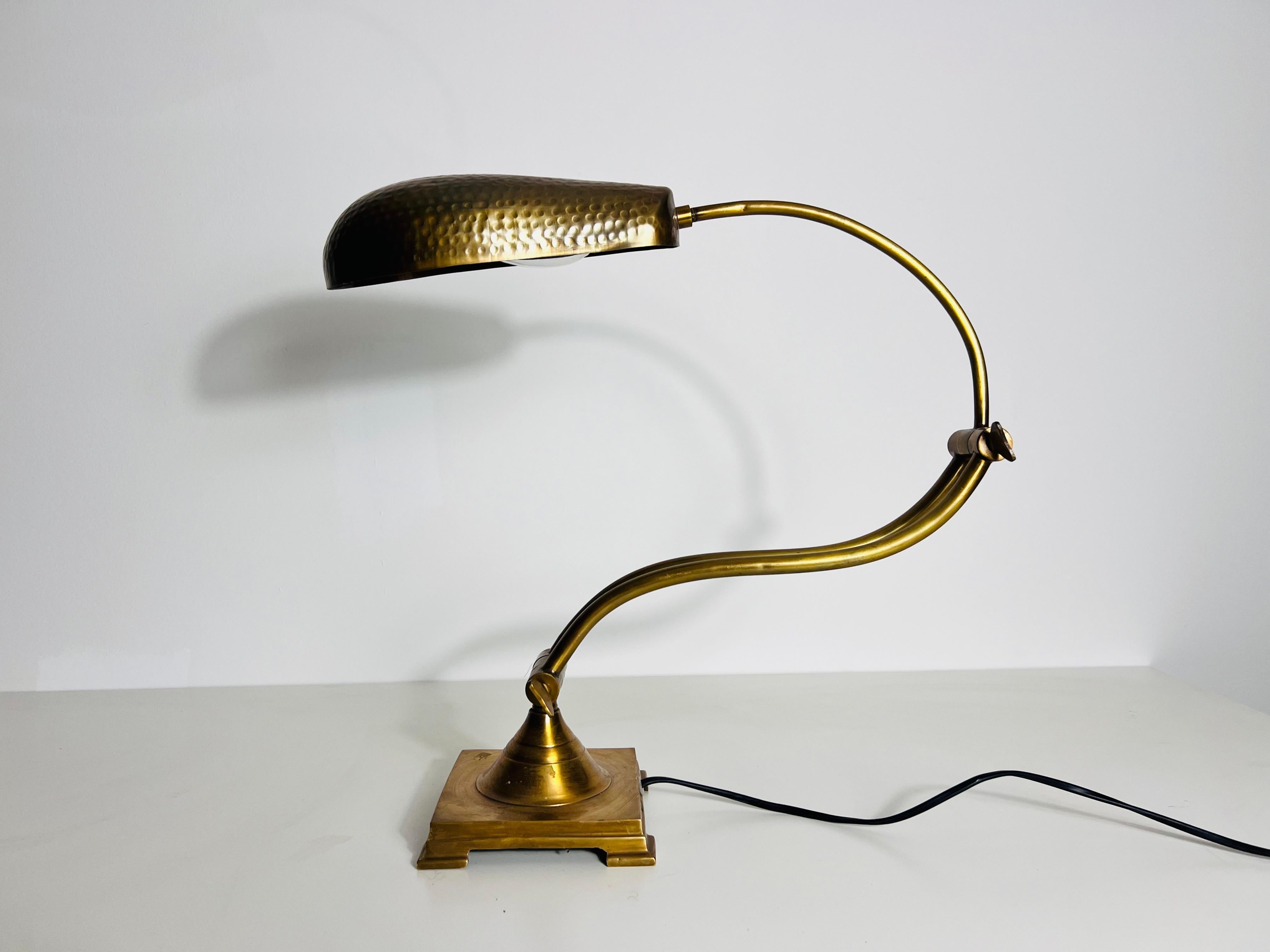 This exquisite brass table lamp from Germany, crafted in the 1960s, is a truly unique piece of design history. The lamp features an elegant shell-shaped lampshade and a fully brass construction, exuding a timeless and sophisticated charm. Its