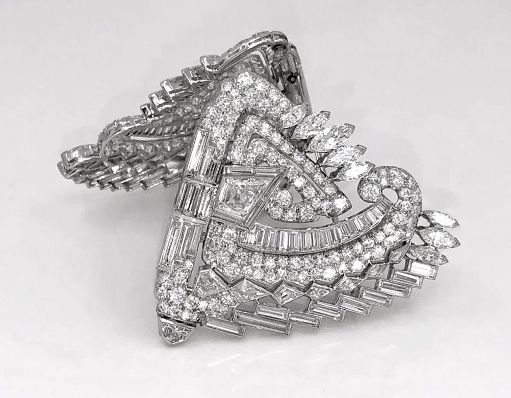 Mid-Century Shield Diamond Double Clip Brooch Pair in Platinum.
A pair of artful clip brooches dating from the 1950s with a gorgeously complex configuration of diamonds. The center point begins with two shield-cut diamonds set diagonally in form.