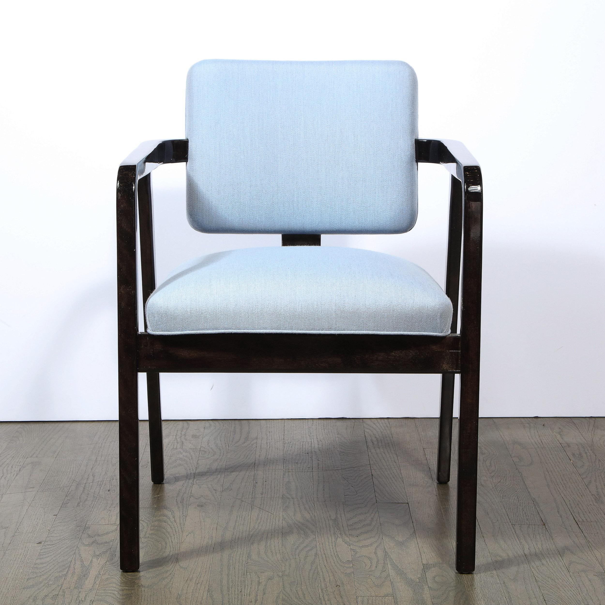 This refined Mid-Century Modern arm/ side chair was designed by the illustrious George Nelson for Herman Miller circa 1950. It offers an angular frame with an arm rest that curves downwards to seamless create the front legs, while the hind legs also