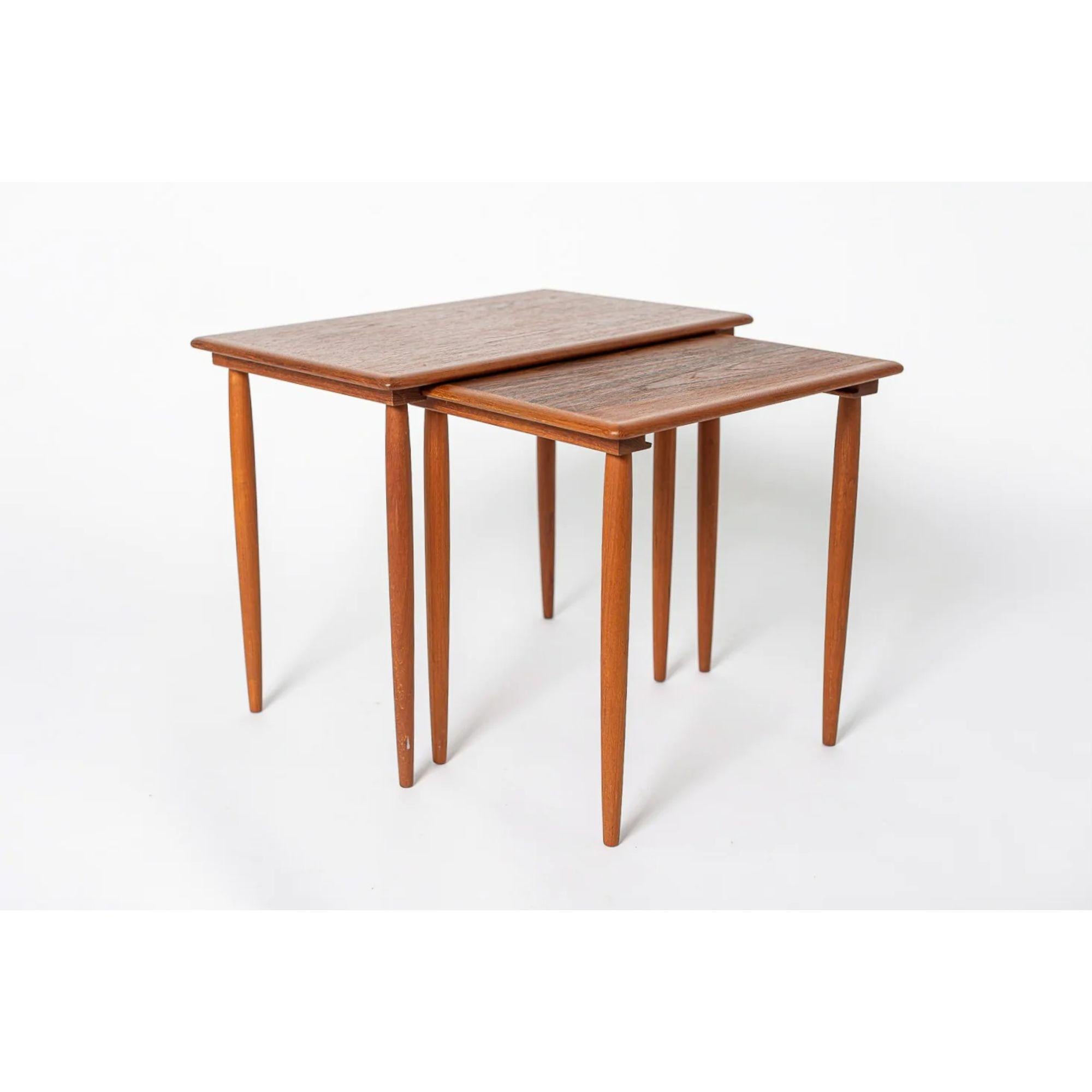 Mid Century Danish Modern Teak Wood Side Nesting Tables

This pair of vintage mid century Danish modern teak side nesting tables are circa 1960. With a classic minimalist Scandinavian design, the end tables have clean lines and gentle curves and
