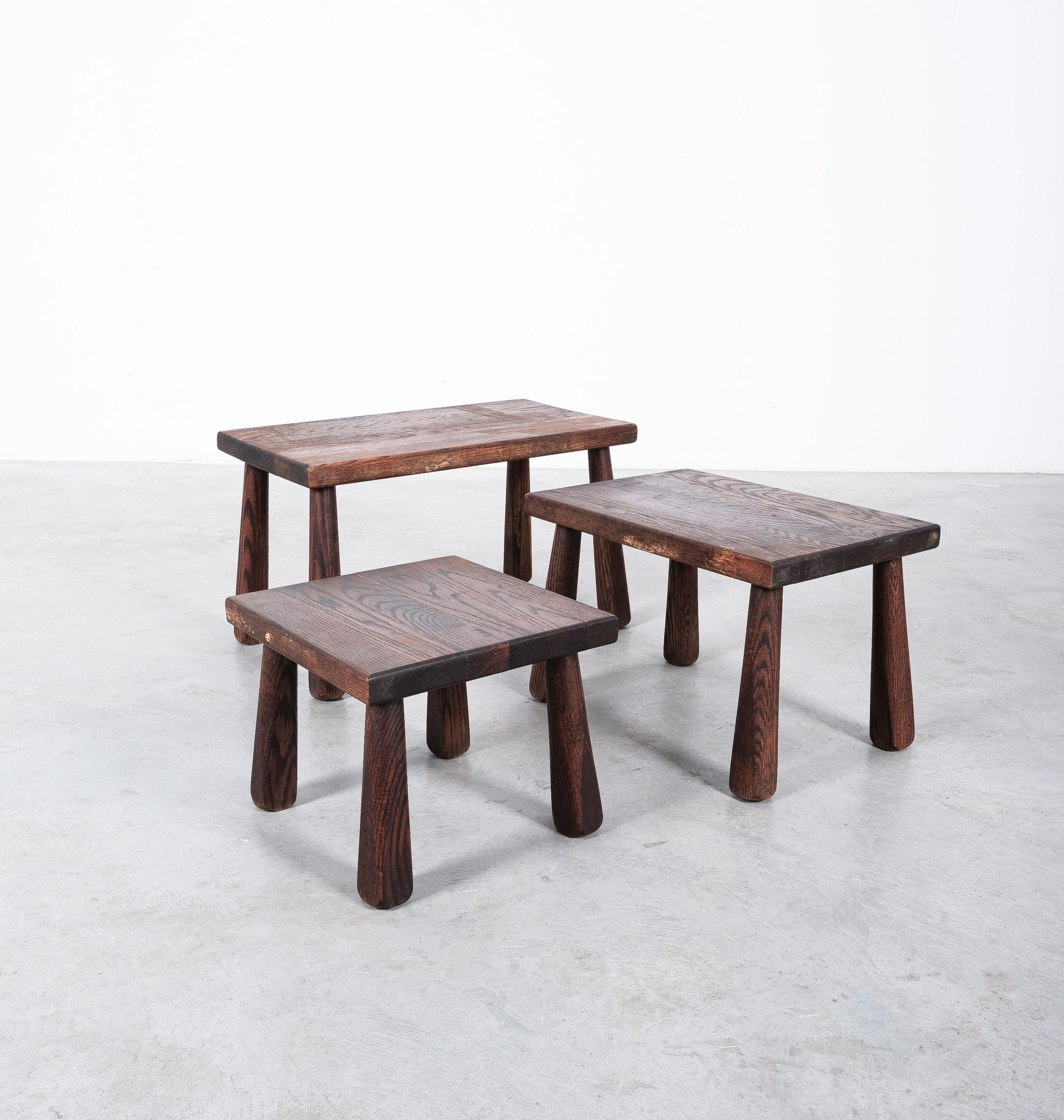 Set of 3 brutalist nesting tables in solid wood, France, circa 1950.

Great set of tables that can either be used as a nest or a cluster. 
The have a particularly nice wood grain and beautiful club-shaped legs.
The tables have been checked by