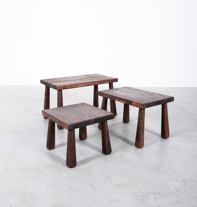 Set of 3 brutalist nesting tables in solid wood, France, circa 1950.

Great set of tables that can either be used as a nest or a cluster. 
The have a particularly nice wood grain and beautiful club-shaped legs.
The tables have been checked by