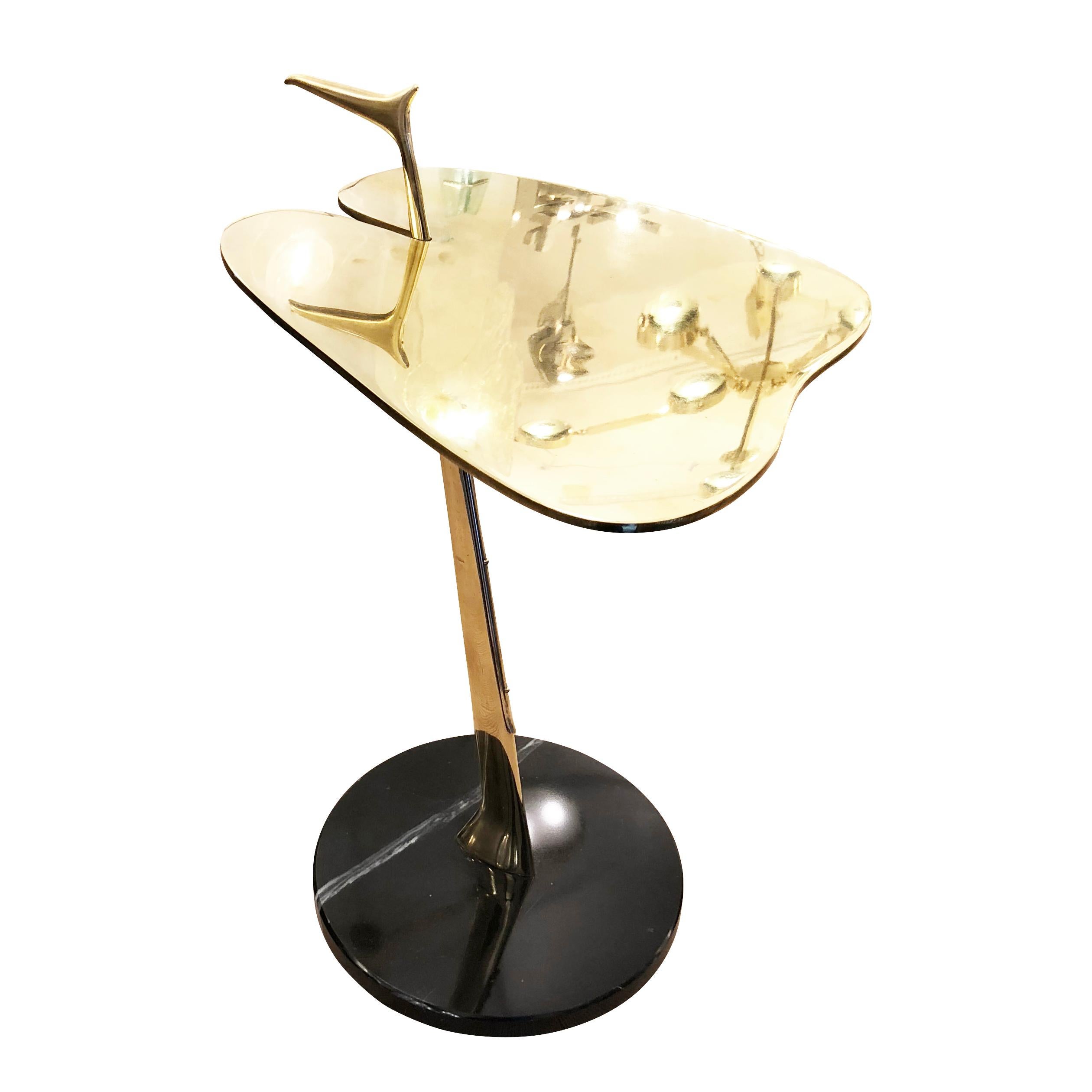 Rare side table with an organically shaped top and slanted support ending in a black marble base. Brass and marble construction. The handle with its distinctive shape is a great detail to note.

Condition: Excellent vintage condition, minor wear
