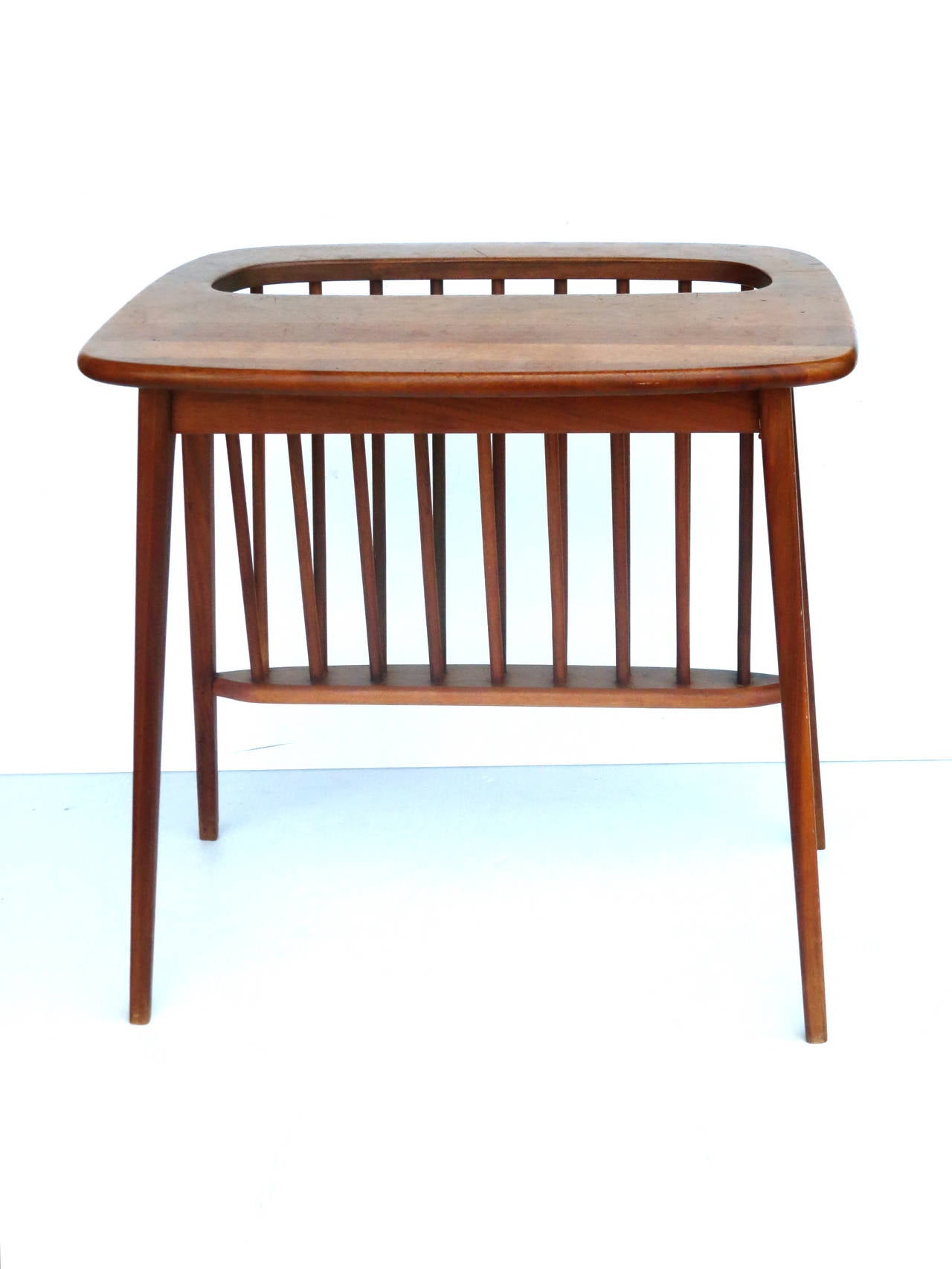 Stunning midcentury side table / magazine rack in solid walnut by Arthur Umanoff, circa 1950s. This beautiful and rare California design piece has been freshly refinished and is solid and sturdy. Great complimentary piece to any MCM room!