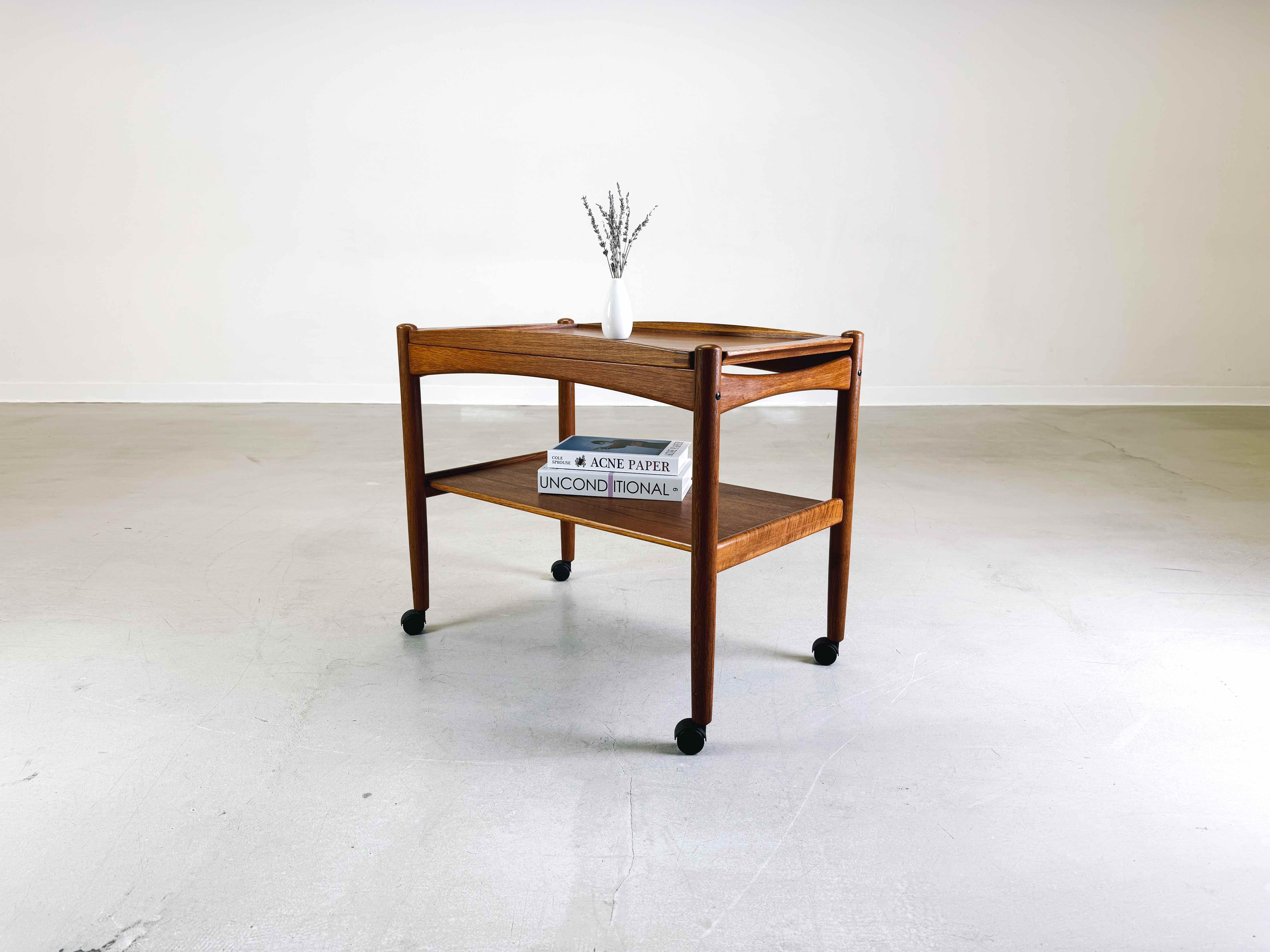 Wir bieten einen schönen Servierwagen der Bernstorffsminde Møbelfabrik aus den 1960er Jahren zum Verkauf an. Das Design stammt von Poul Hundevad und besticht durch seine zeitlose Eleganz und die praktische abnehmbare Tischplatte, die auch als