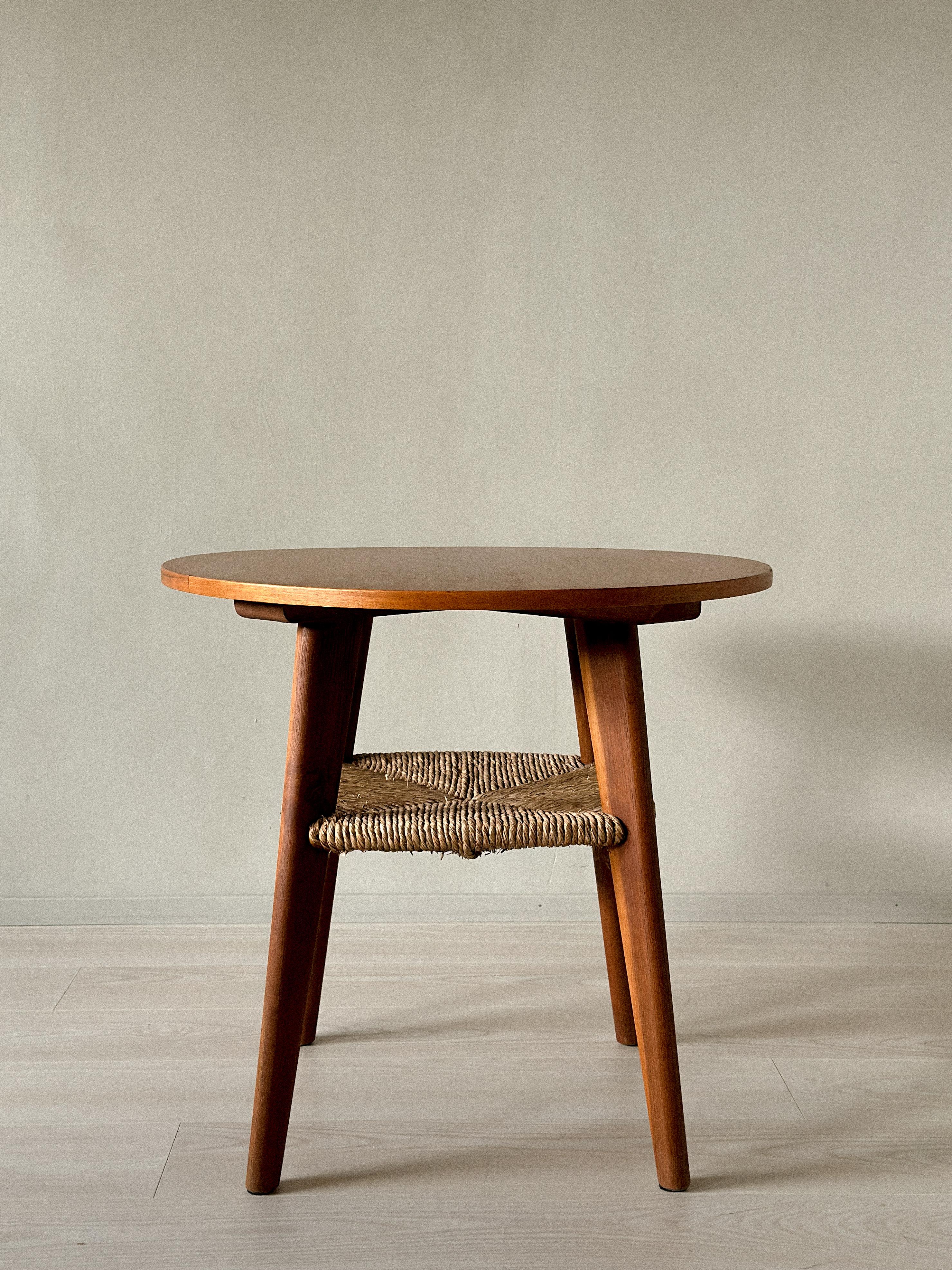 Rare side table by unknown designer, Denmark, c. 1960s. Features a rush shelf and tapered legs. Normal wear consistent with age and use. Marks, scratches