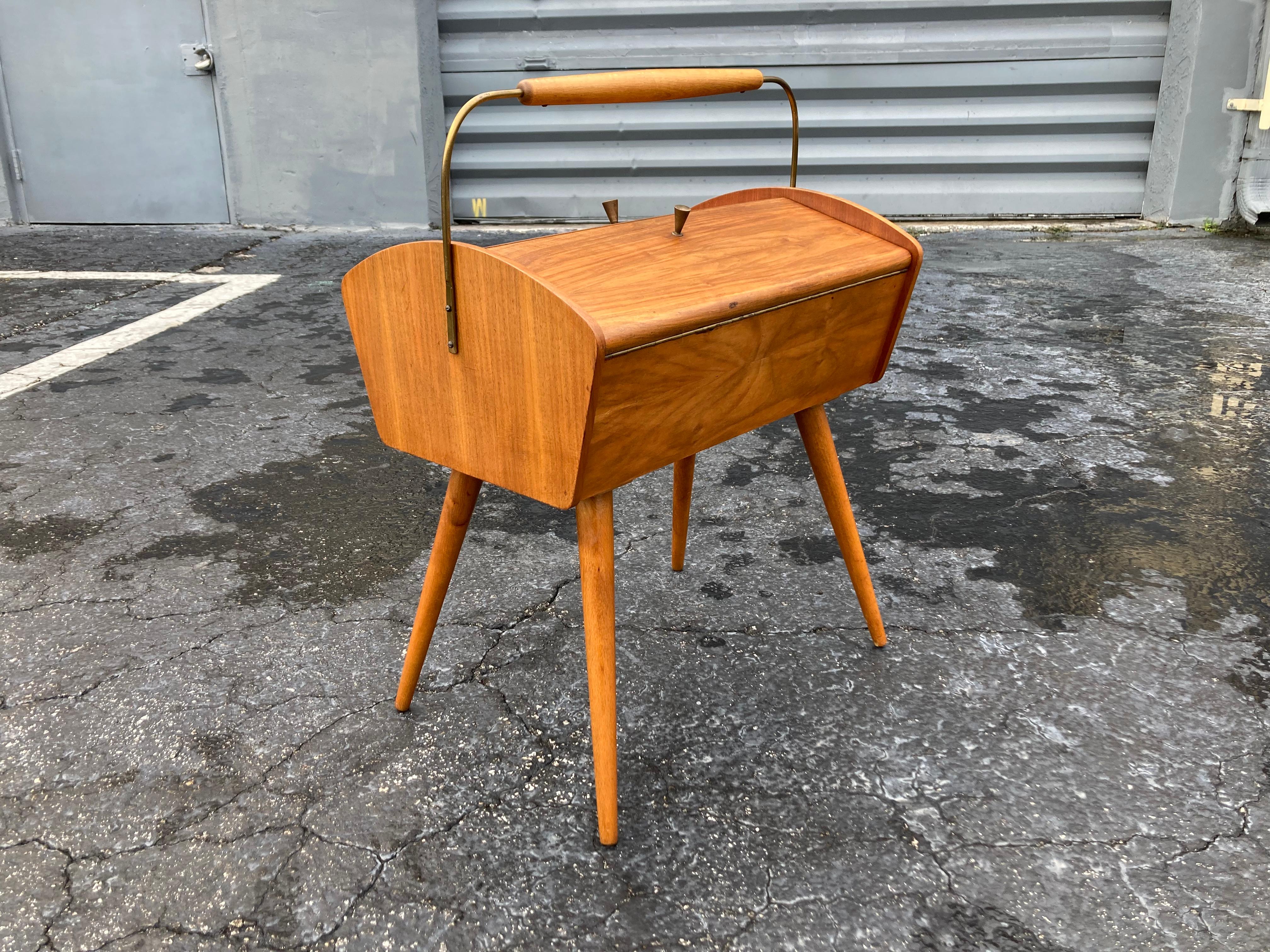 Mid Century Modern side table with storage/sewing box. Most likely German from the 1960s. Great piece, legs unscrew.