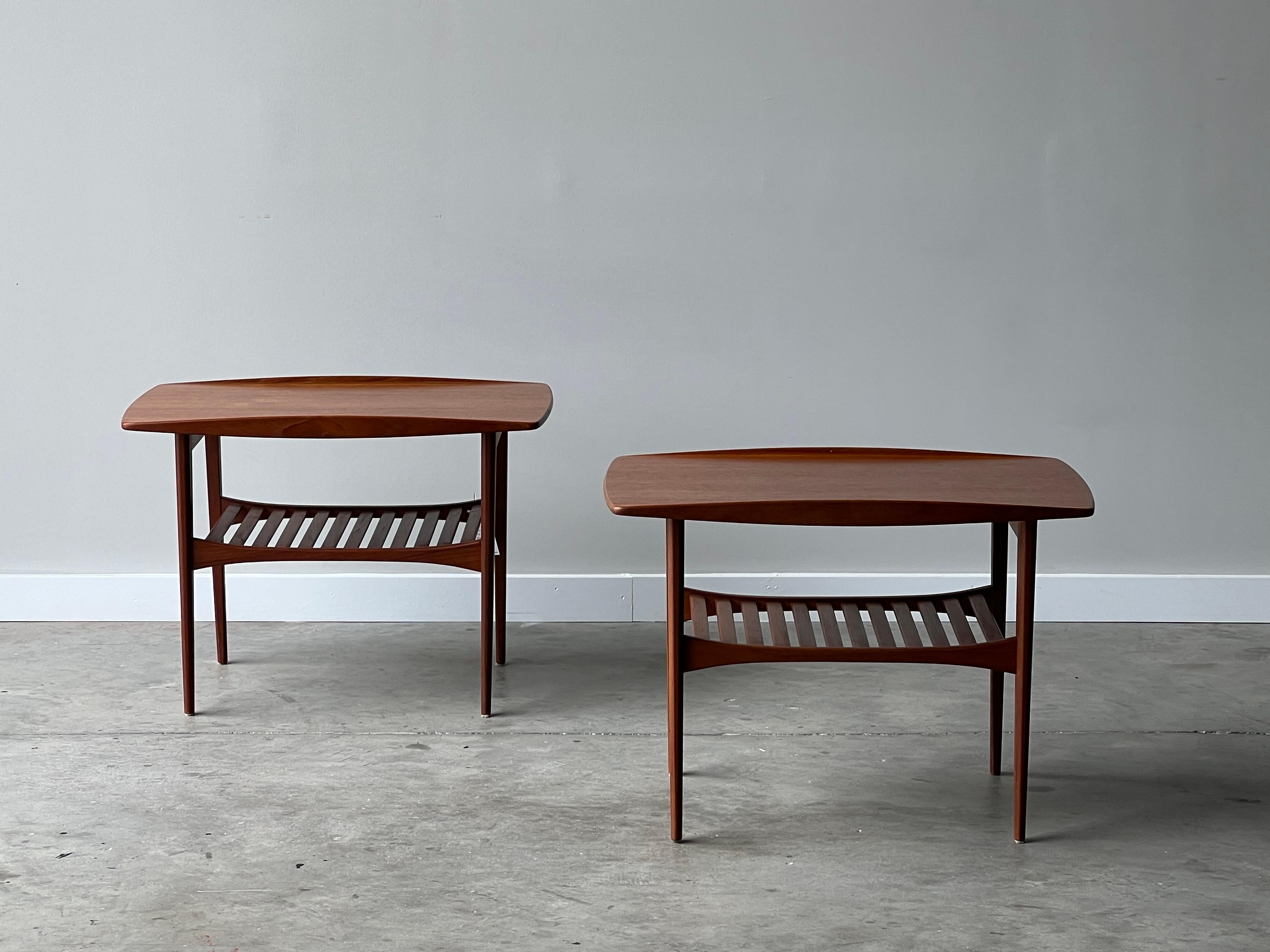 Pair of side tables designed by Grete Jalk for France & Son, Denmark. Made circa 1960s with teak wood. These beautifully crafted end tables have raised fin edges atop and slats below. The wooden slats are perfect for book or magazine storage. In