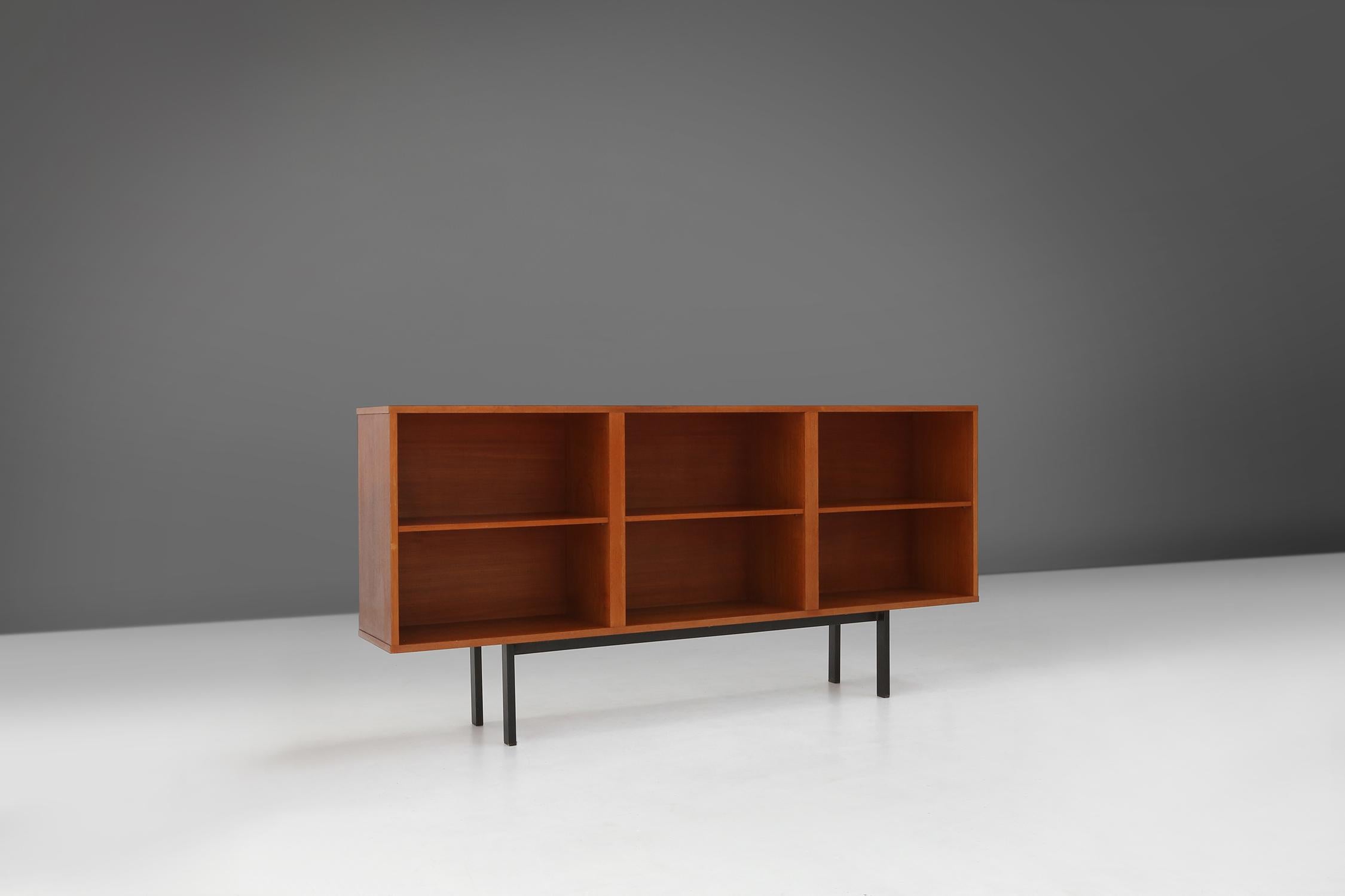 
Made in Belgium in the 1960s, this mid-century sideboard combine clean lines, organic shapes and functional beauty. The teak wood is a durable and natural material, which has a warm and elegant look. The metal base gives a nice contrast to the