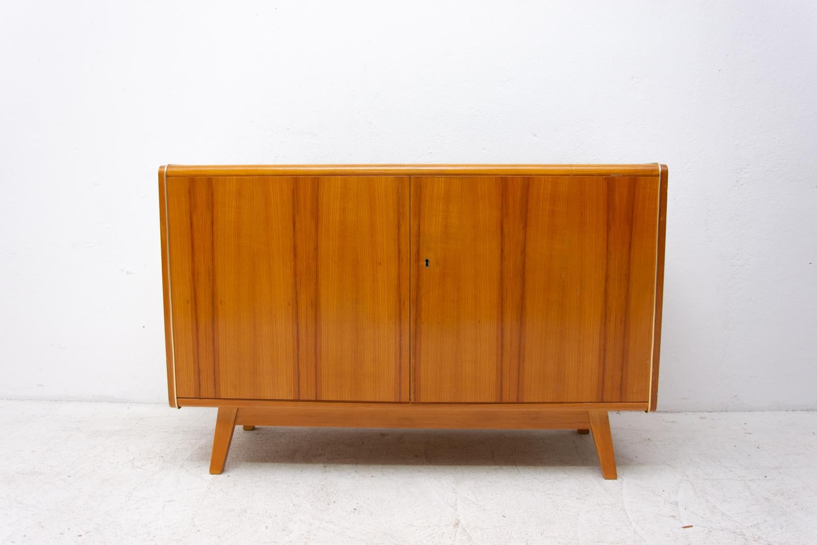 This midcentury sideboard was designed by Hubert Nepožitek & Bohumil Landsman for Jitona company in the 1960s. Material: Beech wood, opaxite glass. In very good condition.