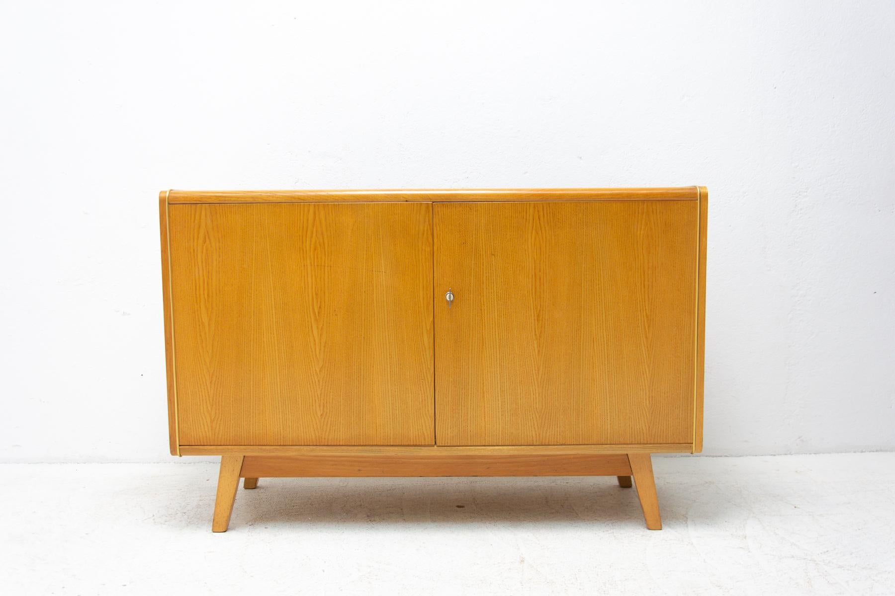 This mid century sideboard was designed by Hubert Nepožitek & Bohumil Landsman for Jitona company in the 1960´s. Material: beech wood, opaxite glass. In good Vintage condition, showing signs if age and using.
  