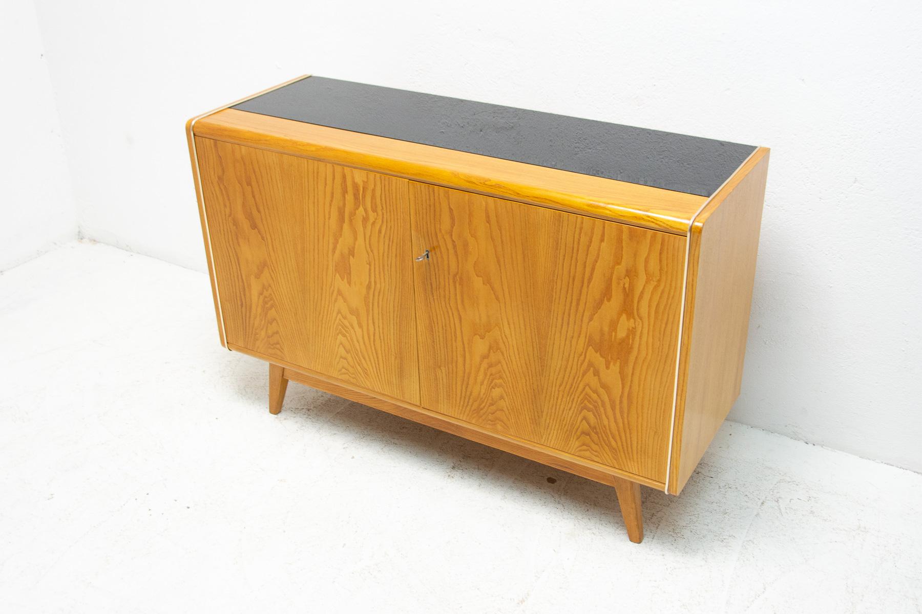 This mid century sideboard was designed by Hubert Nepožitek & Bohumil Landsman for Jitona company in the 1960´s. Material: beech wood, opaxite glass. In very good vintage condition, showing slight signs if age and using.