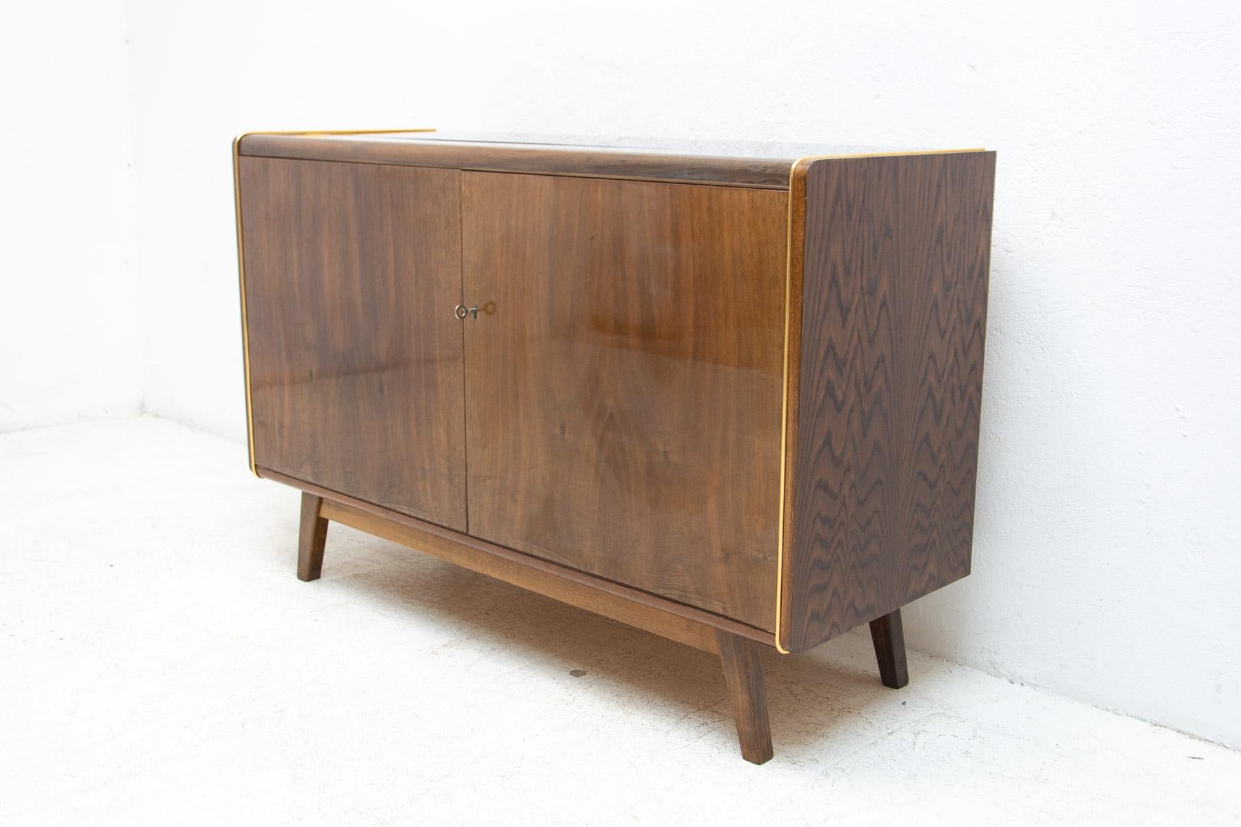 This mid-century sideboard was designed by Hubert Nepožitek & Bohumil Landsman for Jitona company in the 1960´s. Beautiful walnut veneer. Material: walnut, mahogany, plywood, opaxite glass on the top. In very good condition.

Height: 78