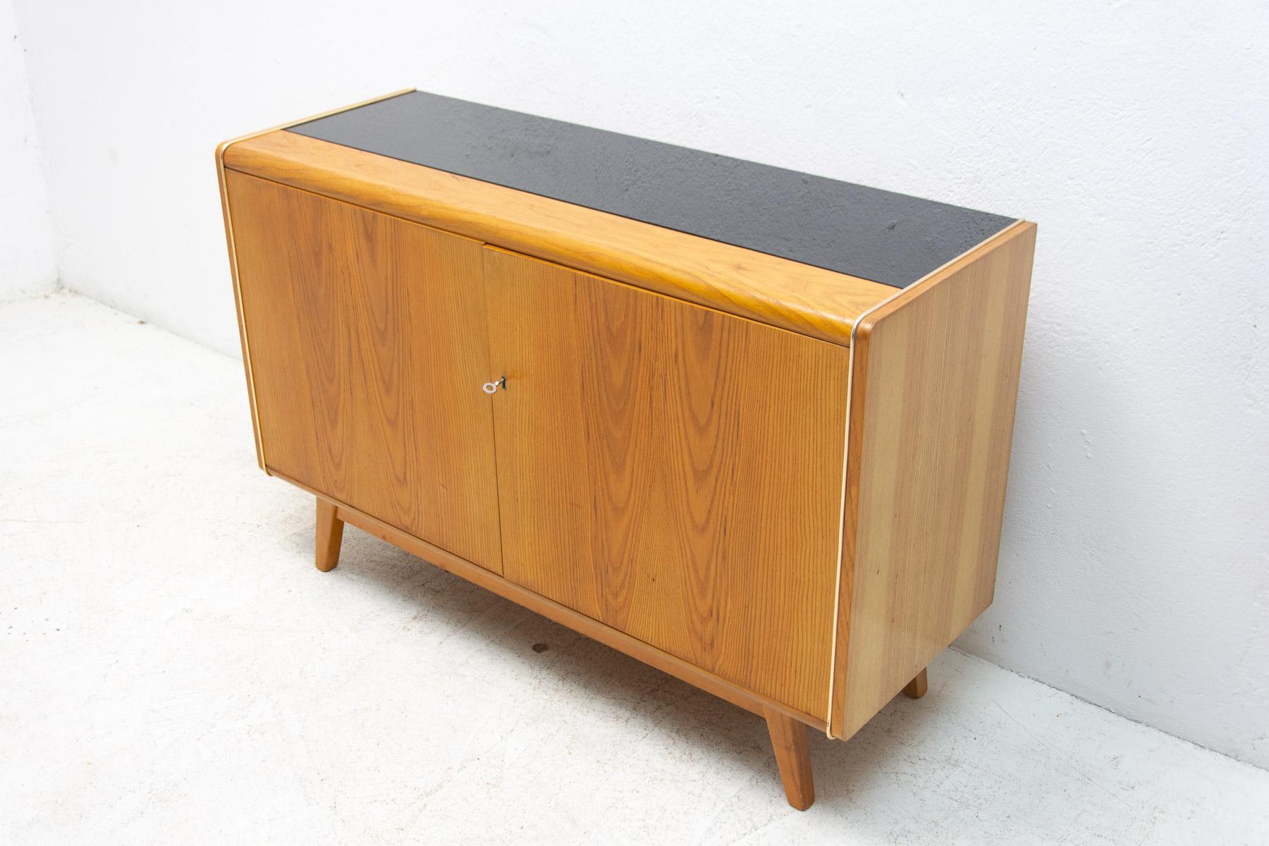 This mid century sideboard was designed by Hubert Nepožitek & Bohumil Landsman for Jitona company in the 1960´s. Beautiful walnut veneer. Material: walnut, mahogany, plywood, opaxite glass on the top. In good Vintage condition.

Measures: Height: