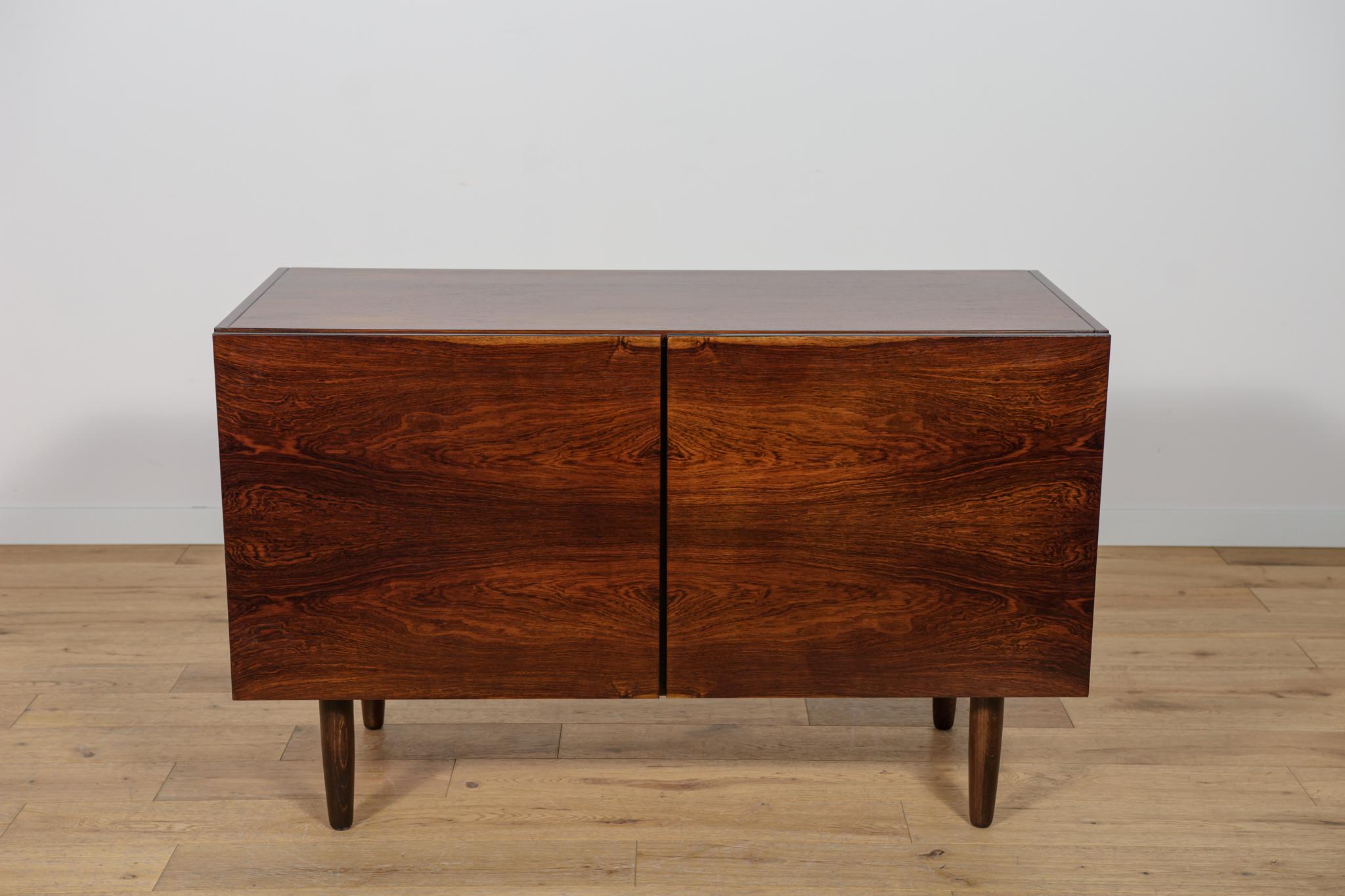 A sideboard designed by the Danish designer Ib Kofod-Larsen, produced in the 1960s in the Danish factory Faarup Mobelfabrik. The sideboard is made of rosewood. The sideboard has undergone a comprehensive carpentry renovation. The chest of drawers