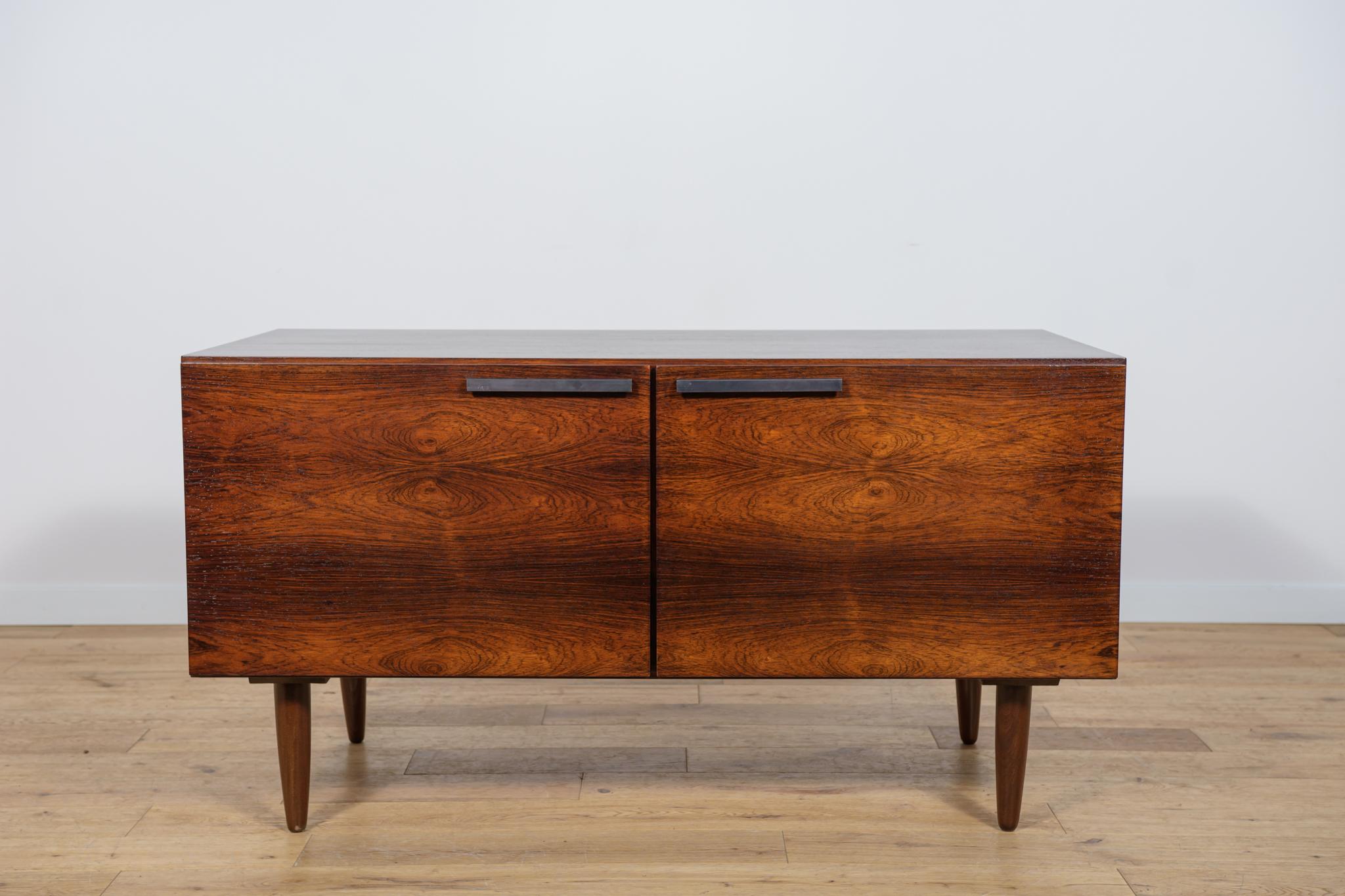 A sideboard designed by the Danish designer Ib Kofod-Larsen, produced in the 1960s in the Danish factory Faarup Mobelfabrik. The sideboard is made of rosewood. The sideboard has undergone a comprehensive carpentry renovation. The chest of drawers