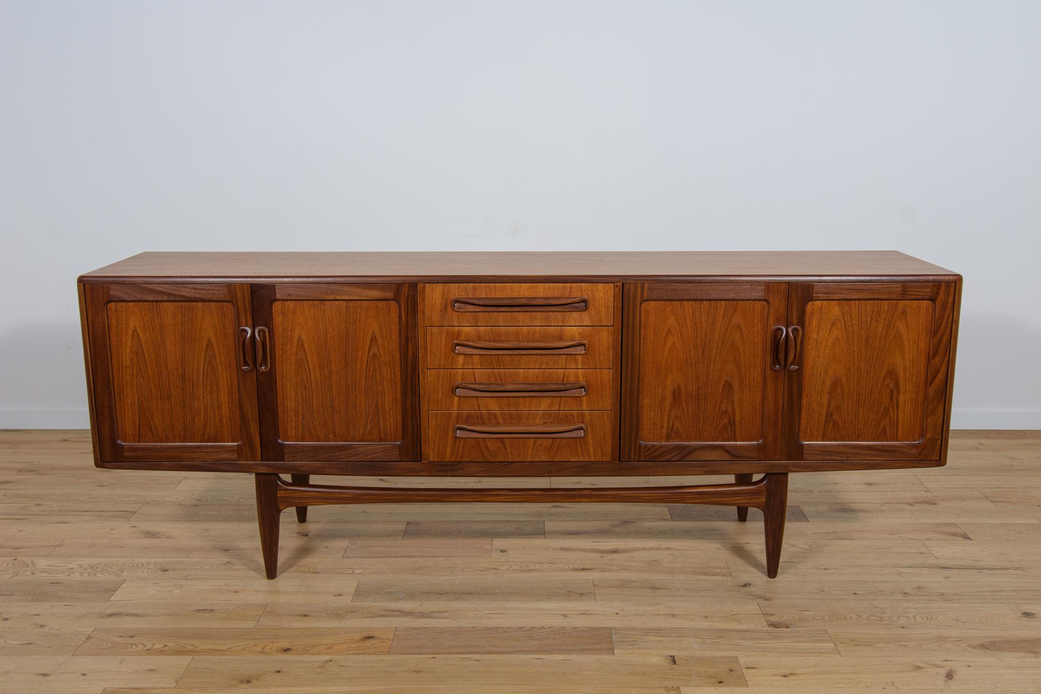 Sideboard  is part of the fresco series and in teak designed by Victor Wilkins for G-Plan in the 60s. It is an exceptionally well-balanced design with dark Afromosia sculpted handles and trim contrasting against the teak veneer. It sits upon an