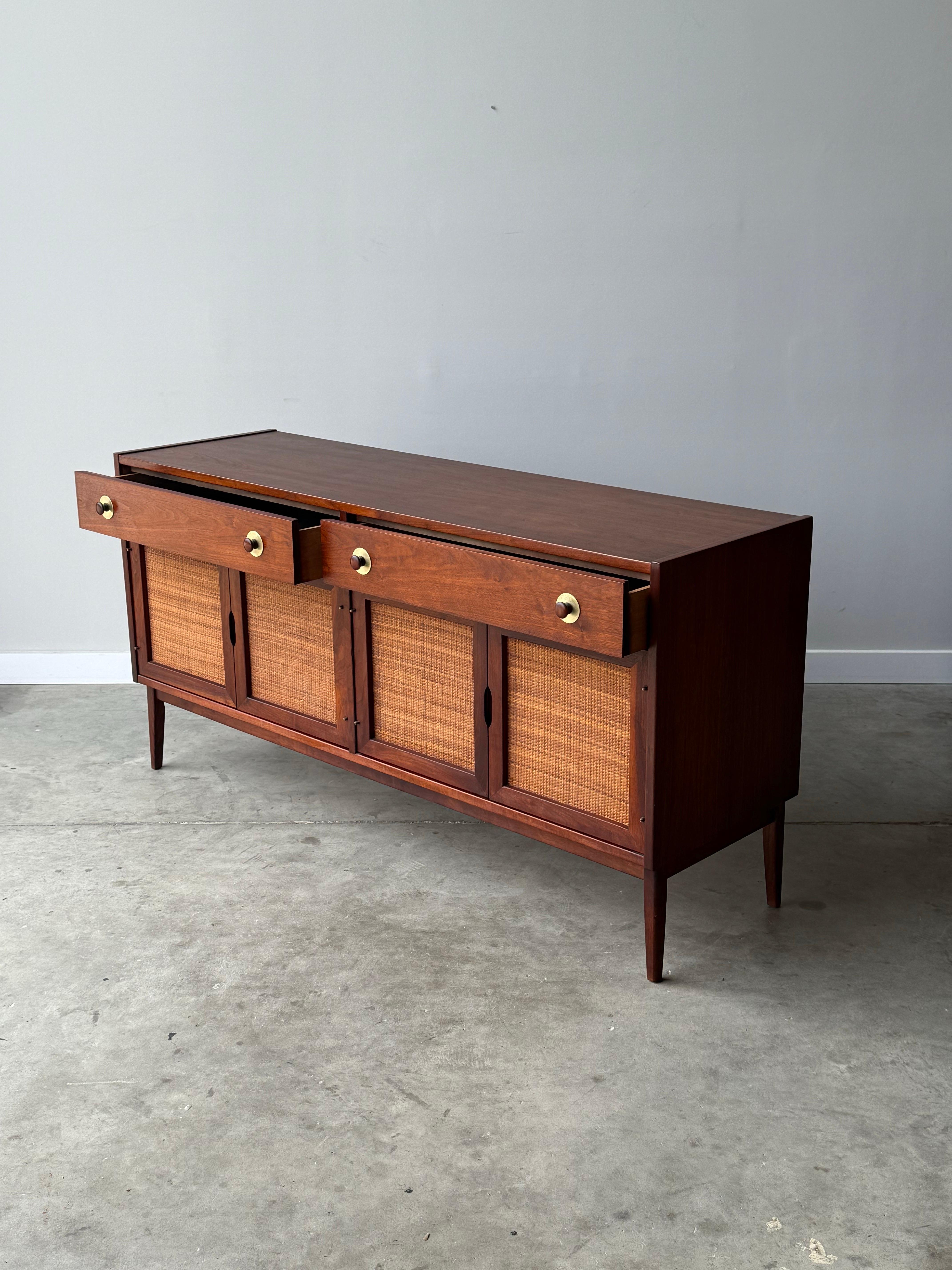 Mid-century credenza by Jack Cartwright for Founders, circa 1960s. A striking example of mid-century modern design, blending functionality with a sleek, timeless aesthetic. Crafted from rich, warm-toned walnut wood.

The credenza features a