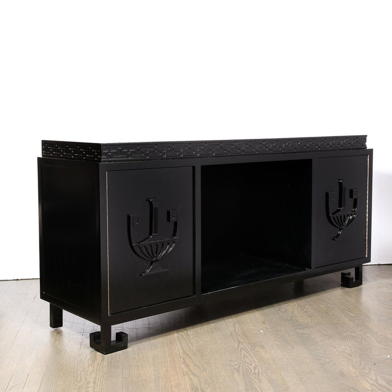 This stunning Mid-Century Modern black lacquer sideboard was realized by the legendary designer James Mont in the United States circa 1950. The hind legs of the piece are straight, volumetric rectangular forms, while the front legs have two L-shaped