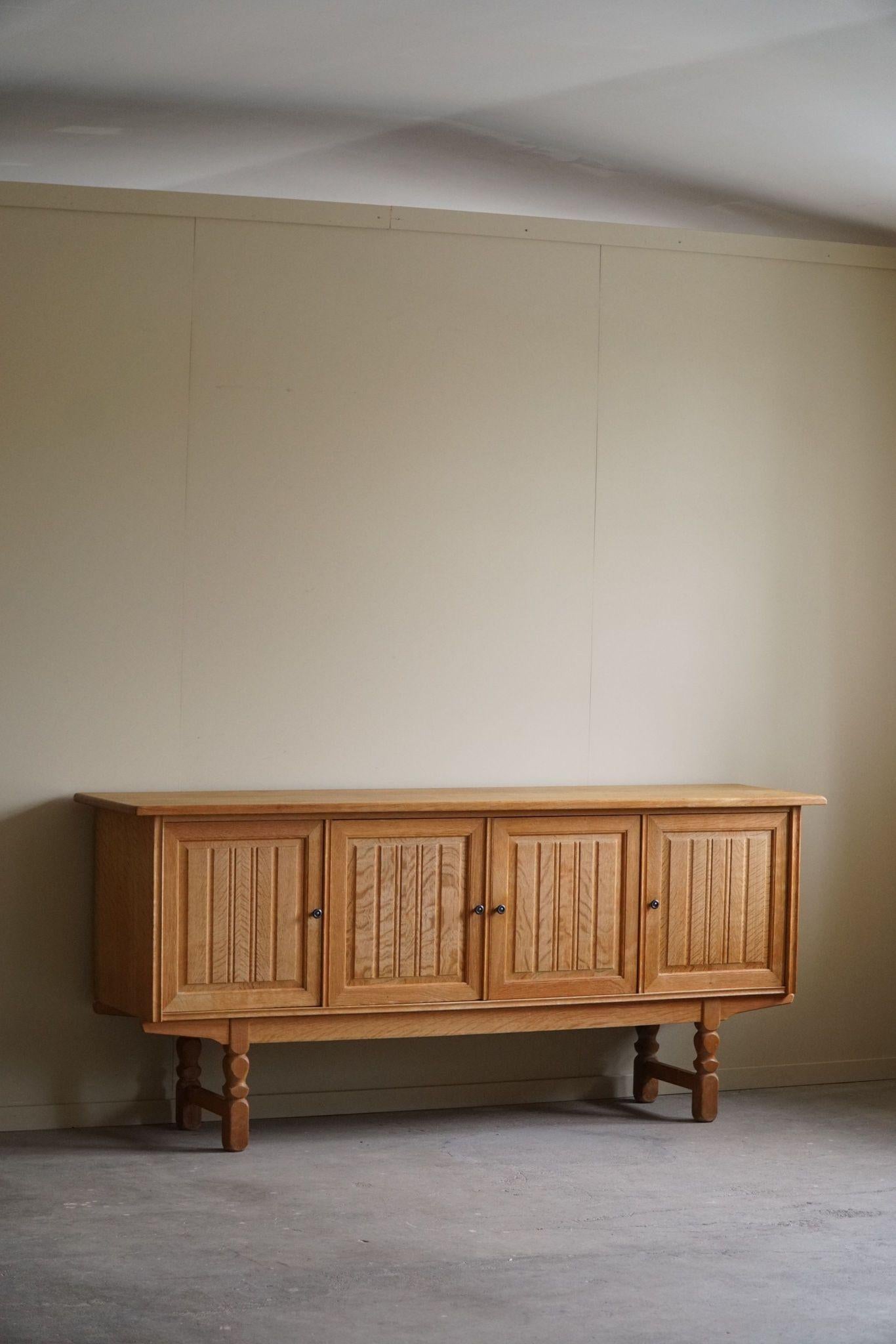 A classic rectangular sideboard / cabinet in oak with great storage space and a refined carved front design. Made by a Danish cabinetmaker in the 1960s.
This piece is in a good vintage condition. 

This intriguing brutalist sideboard will complement