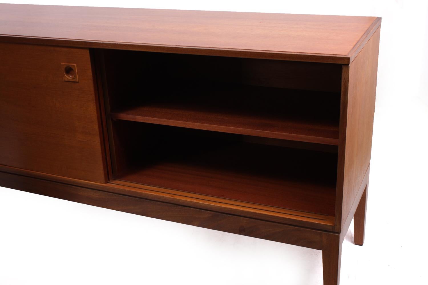 Midcentury sideboard in teak by Robert Heritage
This English modern teak sideboard by Robert Heritage and produced by Archie Shine in the late 1960s it is a beautiful blend of traditional and modern. A bank of four drawers sit on the left of the