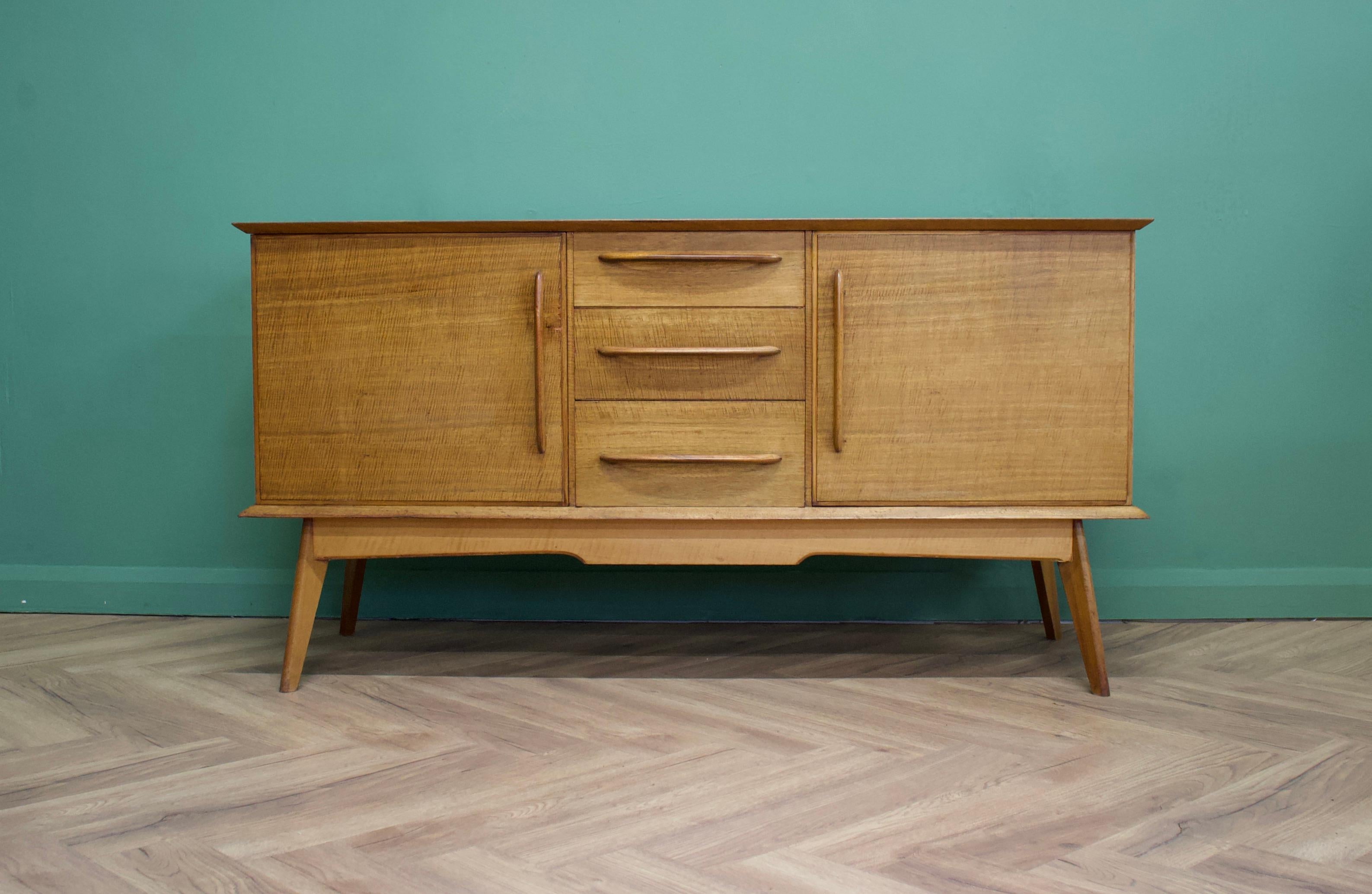 - Midcentury dressing table by Alfred COX.
- Manufactured in the UK.

- Made from walnut & walnut Veneer.

- Featuring two cupboards and three drawers.