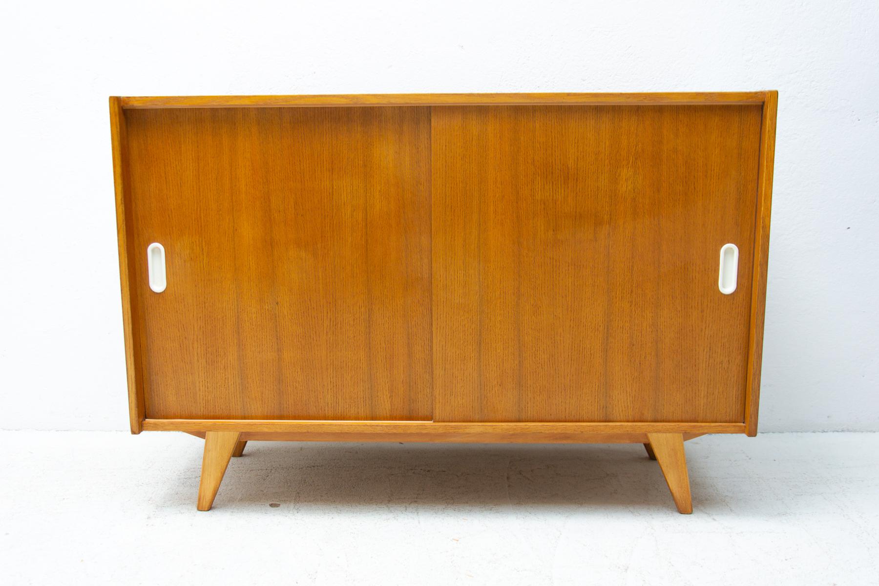 Mid century sideboard with sliding doors and one long shelf inside, designed by Jirí Jiroutek in the 1960´s. It´s made of oak wood. In excellent condition, fully refurbished.