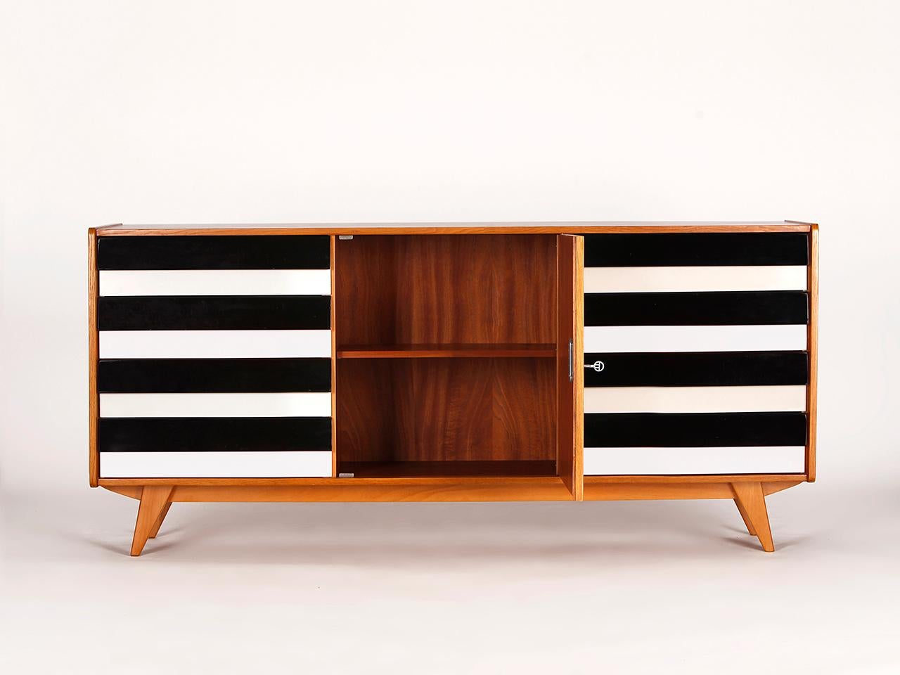 This model U-460 sideboard was designed by Jiri Jiroutek for Interier Praha in former Czechoslovakia. Produced in the 1960s. 
Completely restored. It is an early model with wooden drawers. Excellent condition. Delivery time 3-4 weeks.
