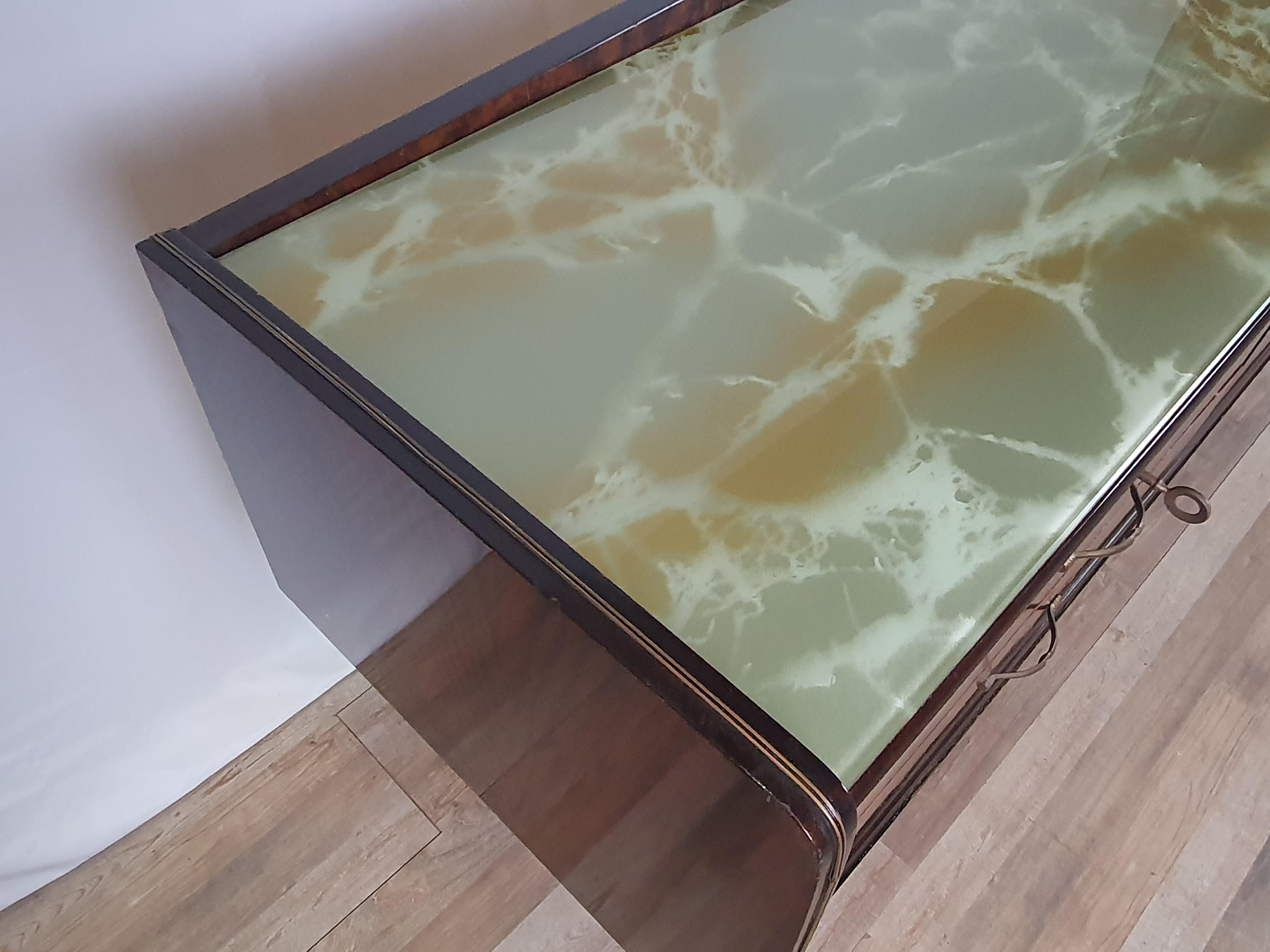 Elegant 1950s chest of drawers of Italian production with worked and decorated glass top.

Handles and feet tips in brass to make the piece of furniture unique and special, adapting it to any context.

The sideboard has been oil rubbed, shows