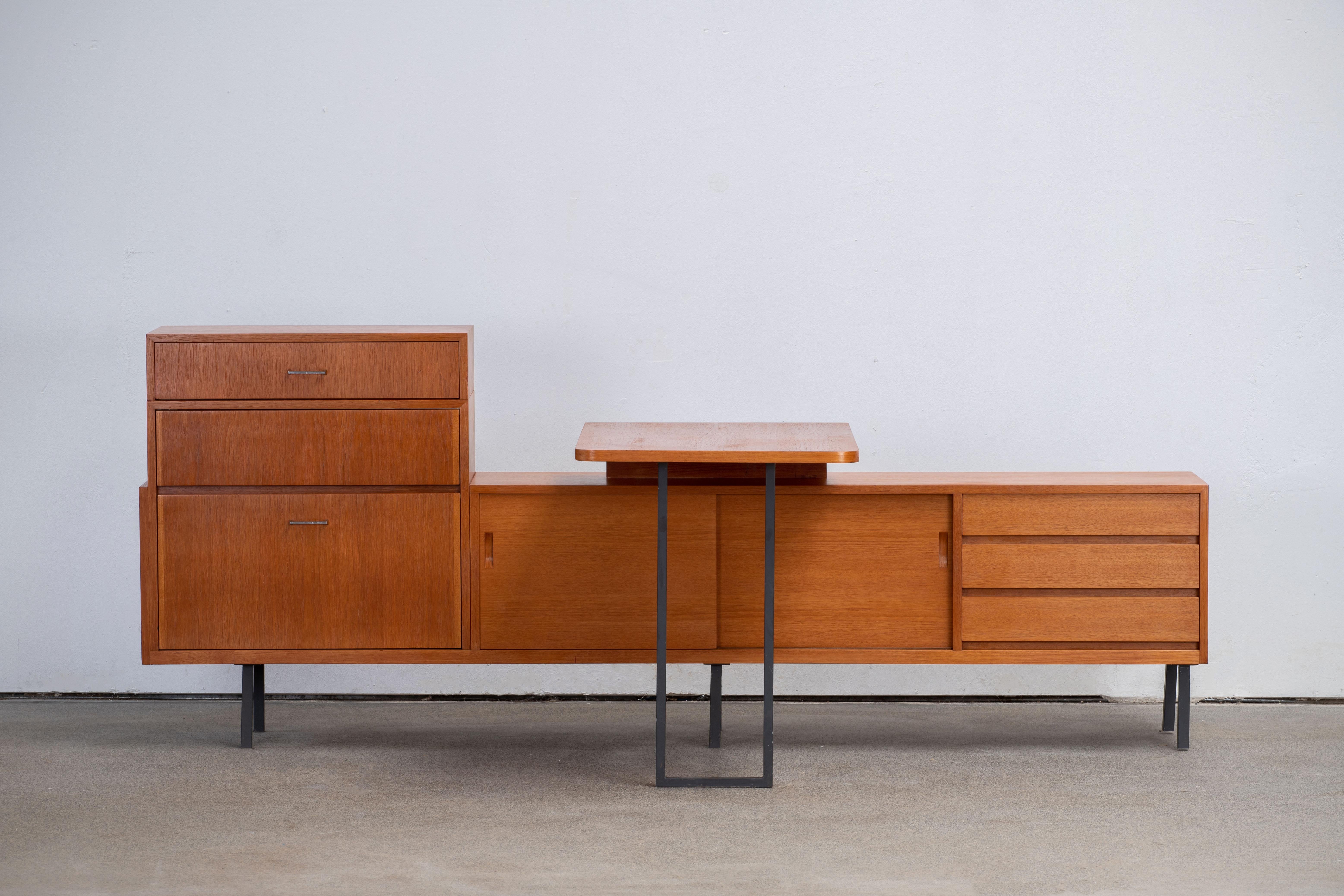 Mid-century sideboard in teak, Germany, 1960s.
This sideboard can evolve in a corner desk, a removable table can be added to it, making of this minimal sideboard a versatile object.
An elegant piece.
Good condition with minor wear.