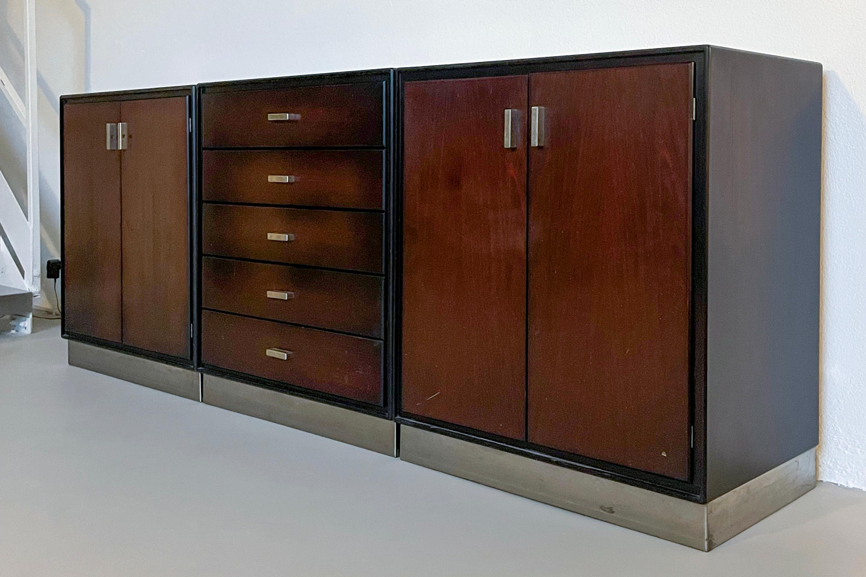 Mid-Century Modern Sideboard - Italian Collectible Design - Dark Wood Cabinets

Set of three modular cabinets/sideboard, designed by Gianni Moscatelli for Italian furniture brand Formanova. Crafted in solid wood with stainless steel details,