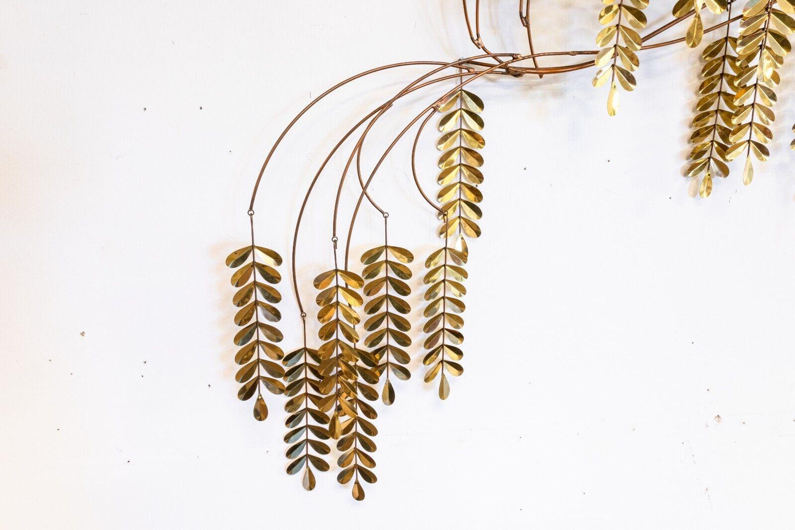 A signed 1985 Curtis Jere Brass Hanging Willow Tree Wall Sculpture. An absolutely wonderful kinetic brass wall sculpture of a willow tree. This piece features large brass rods polished hanging leaves. This piece is signed 