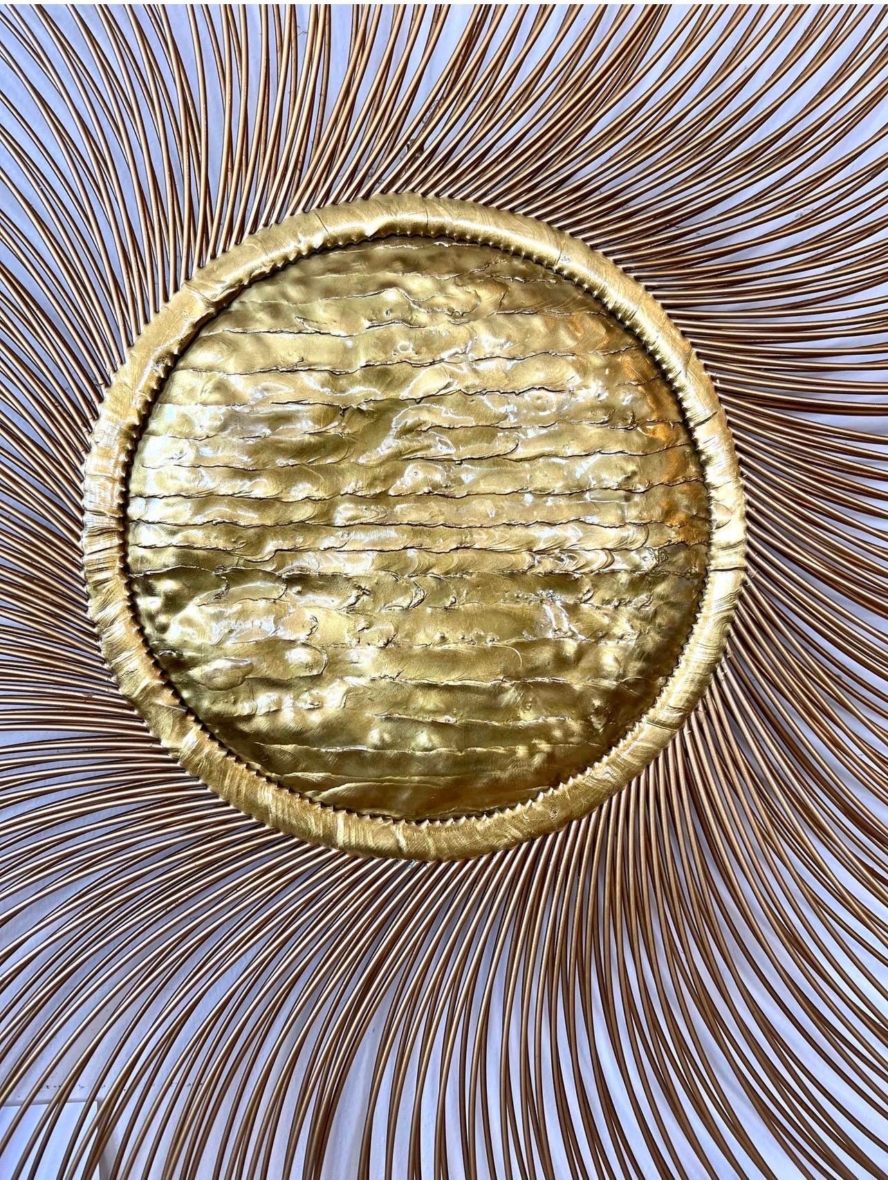 Coveted Casa Devall sunburst wall sculpture with a hammered brass center and two layers of painted rods creating a spiral sunburst effect which is a feast for the eyes! Note spokes have black tips which really makes this sculpture a work of art and