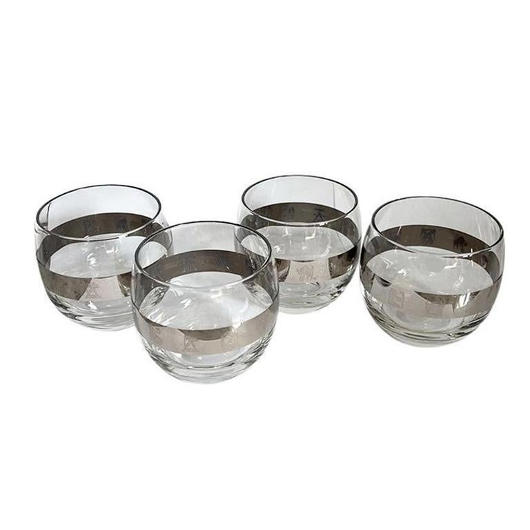 A set of four vintage mid-century modern silver banded roly poly glasses with astrological signs. This glass shape is referred to as 'Roly Poly