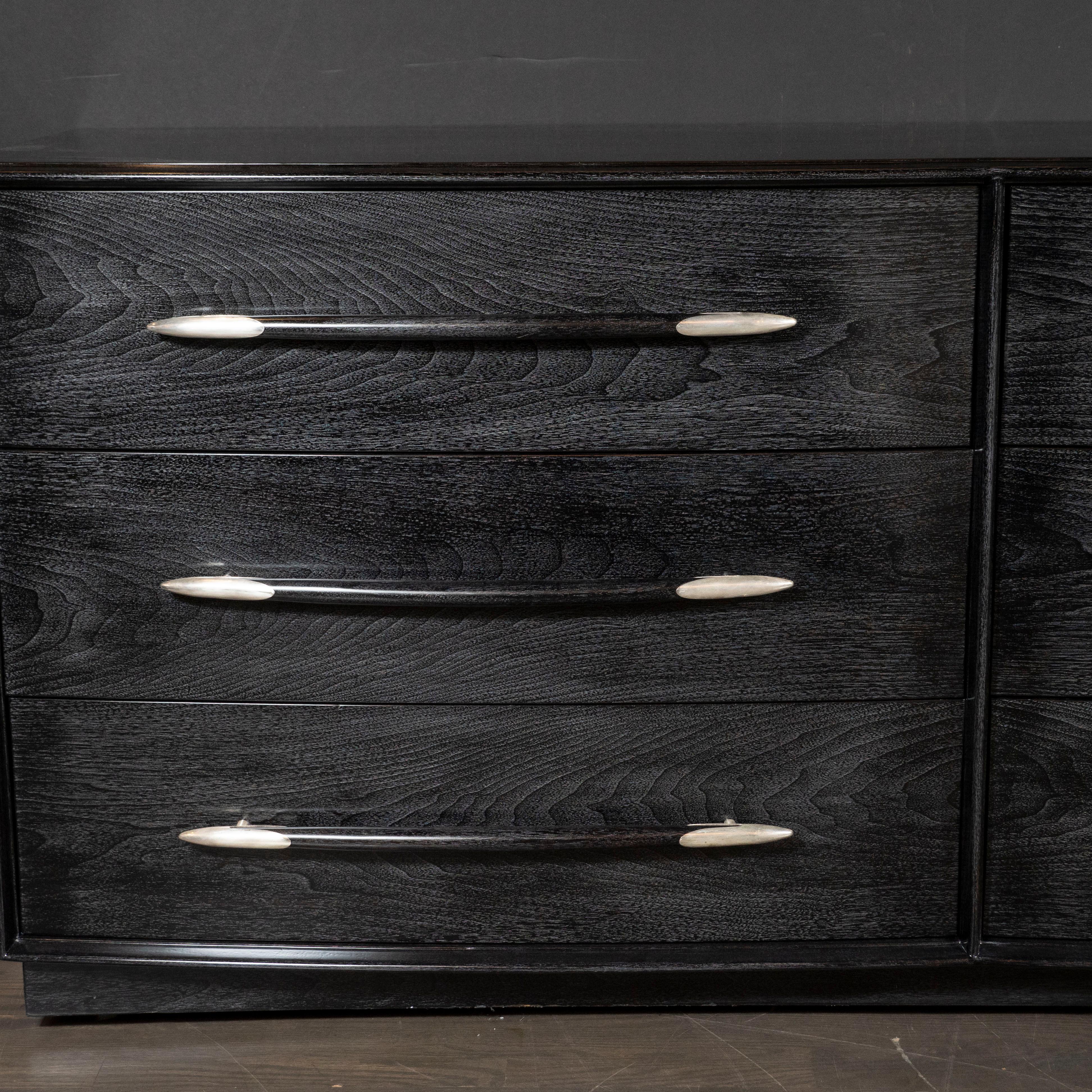 This elegant Mid-Century Modern low chest realized by the design luminary T.H. Robsjohn-Gibbings for the Widdicomb Furniture Co. in America, circa 1950. It features a rectilinear body with six drawers (three on each side)- offering a wealth of