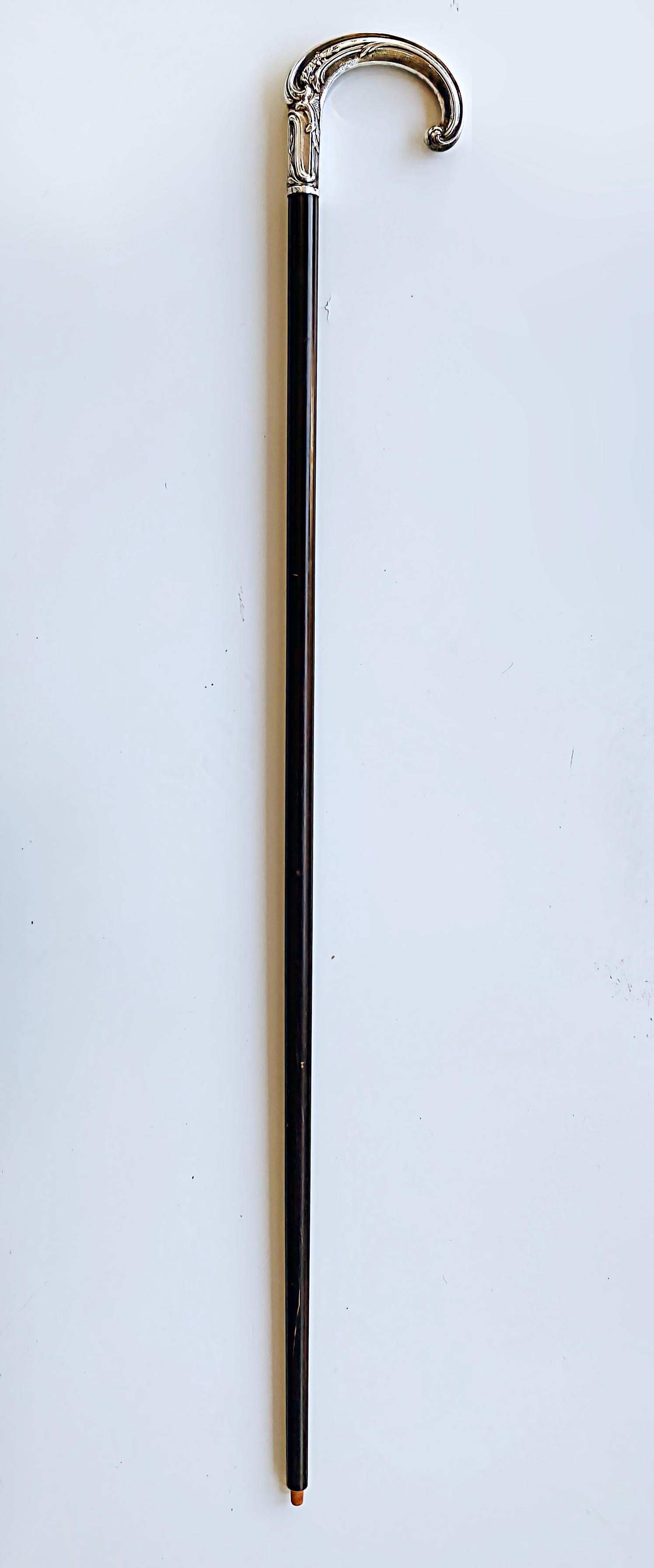 20th century Silver Handle Walking Cane Made in Portugal with Hallmarks

Offered for sale is a mid to late-20th century silver-handled walking stick or cane with an ebonized wood stick. The tip is missing from the end. We don't know if this is