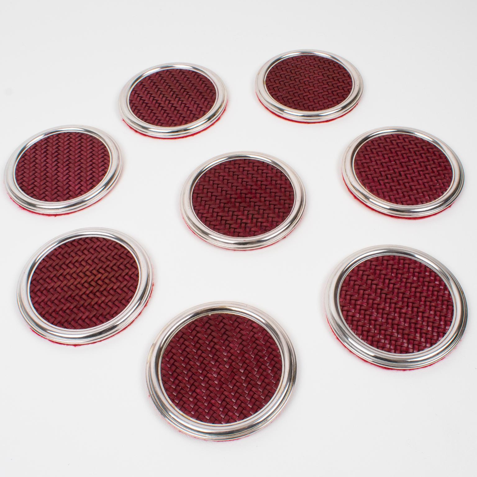 This lovely Mid-Century modernist barware set of eight coasters was crafted in Italy in the 1960s. The rounded shape boasts a silver plate stepped framing complemented by braided genuine red leather with a chevron pattern. The underside is protected