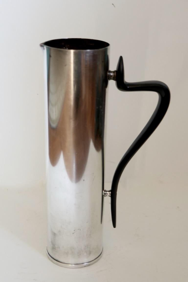 Classic midcentury martini pitcher designed by Donald Colflesh for Gorham, circa 1950s. Dramatic, elegant and exaggerated organic handle, on a sleek cylindrical silver plate body, pure style. This example is in clean original condition, showing only