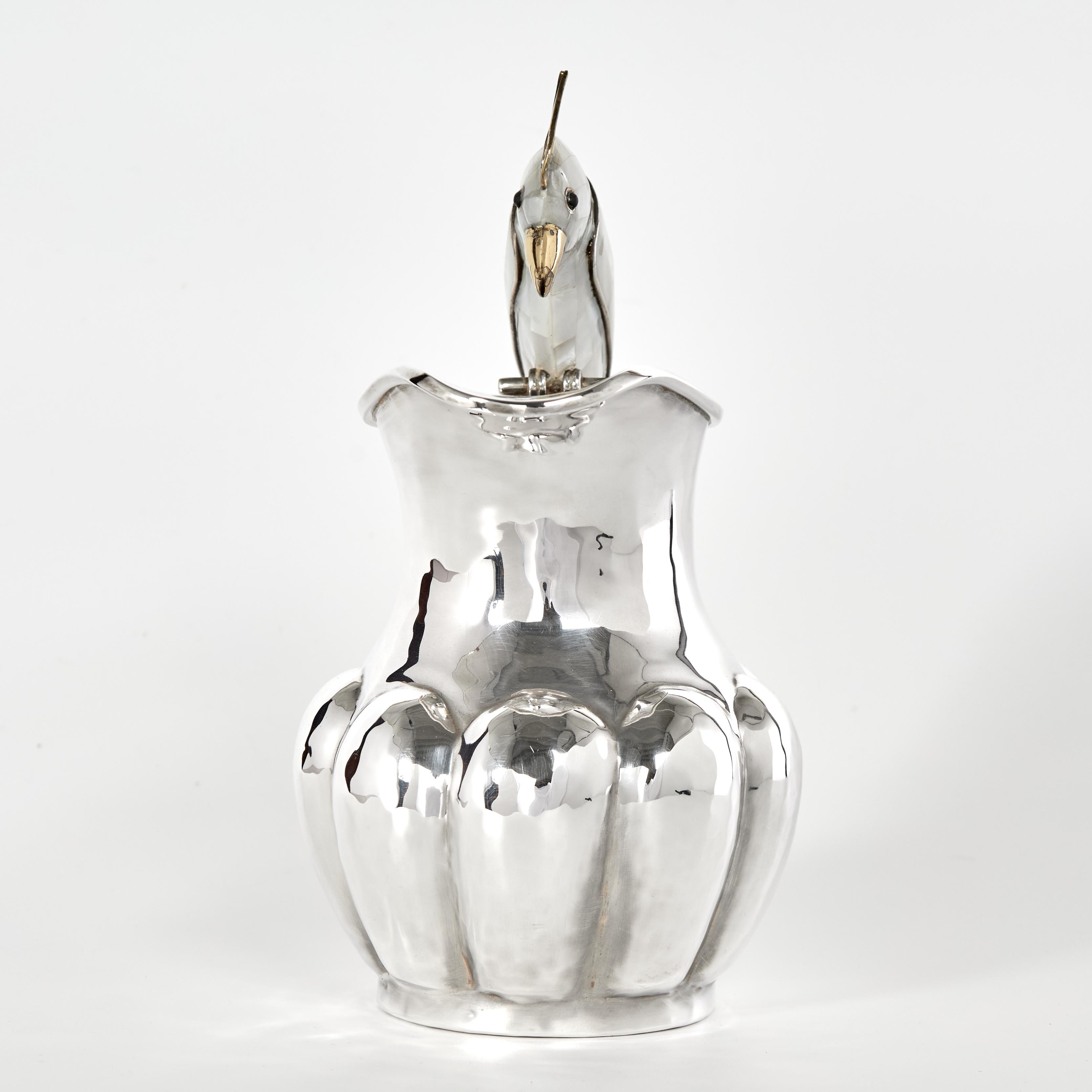 Standout vintage pitcher handcrafted in silver plate on copper in classic modern form featuring a mother of pearl clad parrot as a handle. Stamped Los Castillo on the bottom. 