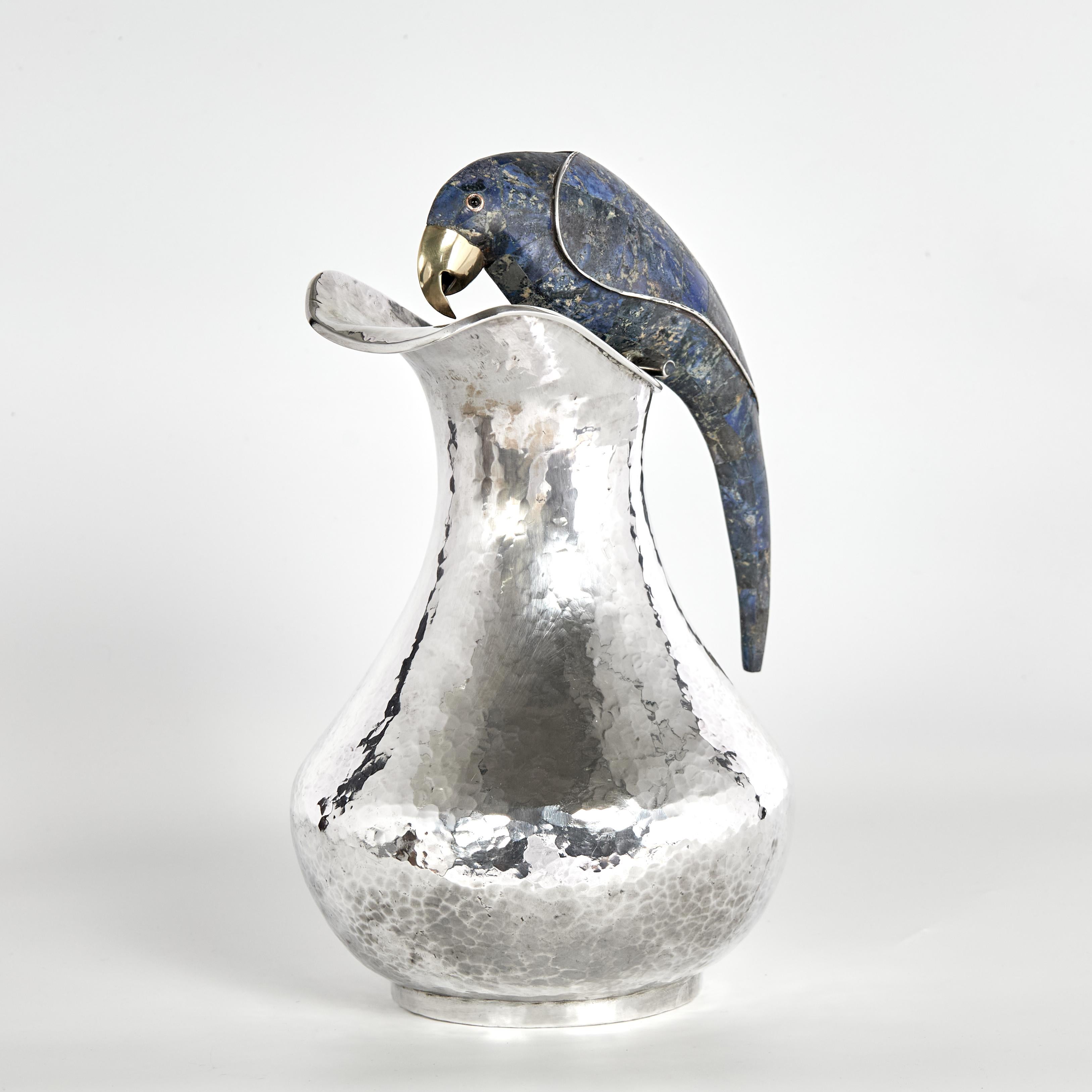 Standout vintage pitcher handcrafted in silver plate over hammered copper in classic modern form featuring a stone clad parrot as a handle. Stamped Los Castillo on the bottom. 