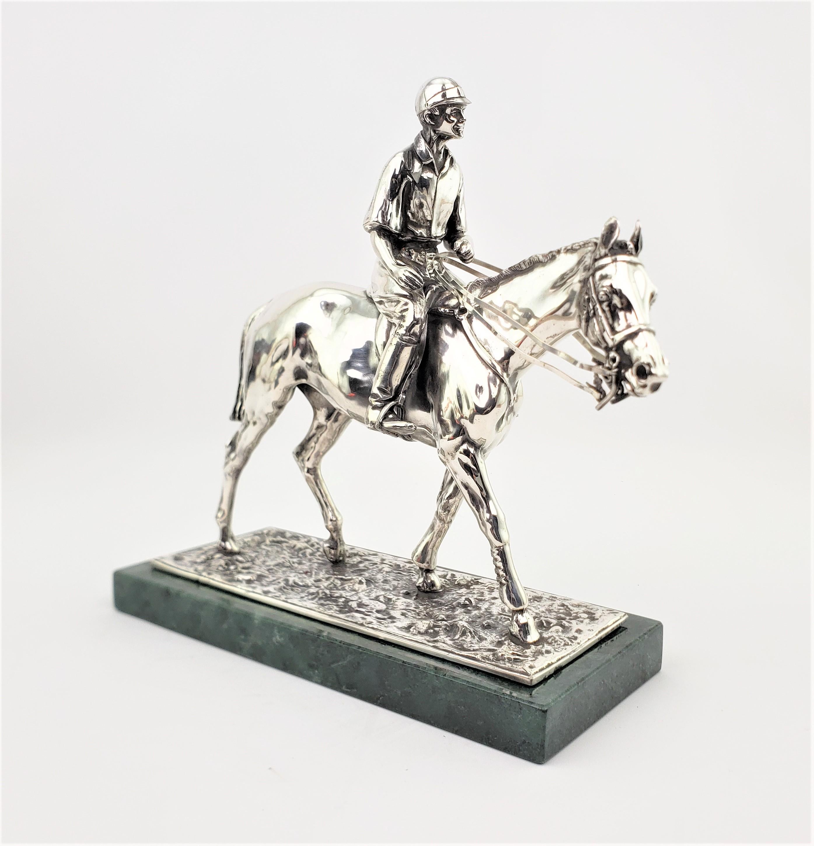 This silver plated metal horse and rider sculpture is initiated, but the artist could not identified. It is presumed that the sculpture was made in the United States in approximately 1965 in the period mid-century style. The sculpture is done in a