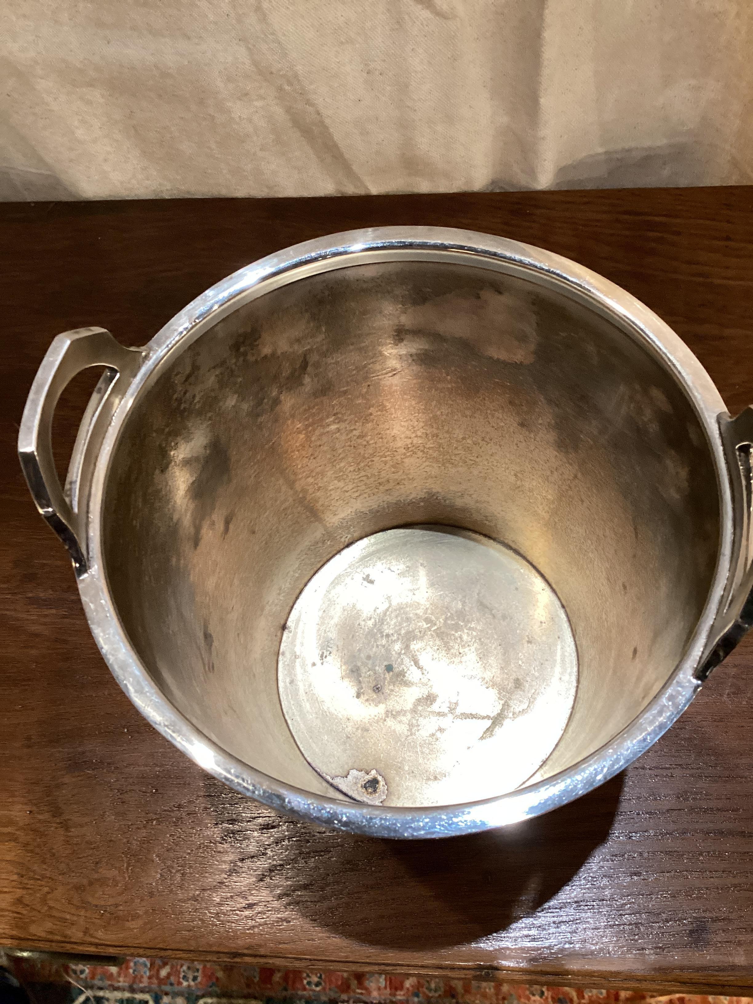 Mid Century Silver Plated Champagne Bucket with Stand. Bucket opening measures 6” and 7.5” in depth. Silver has recently been polished and is in good vintage condition.